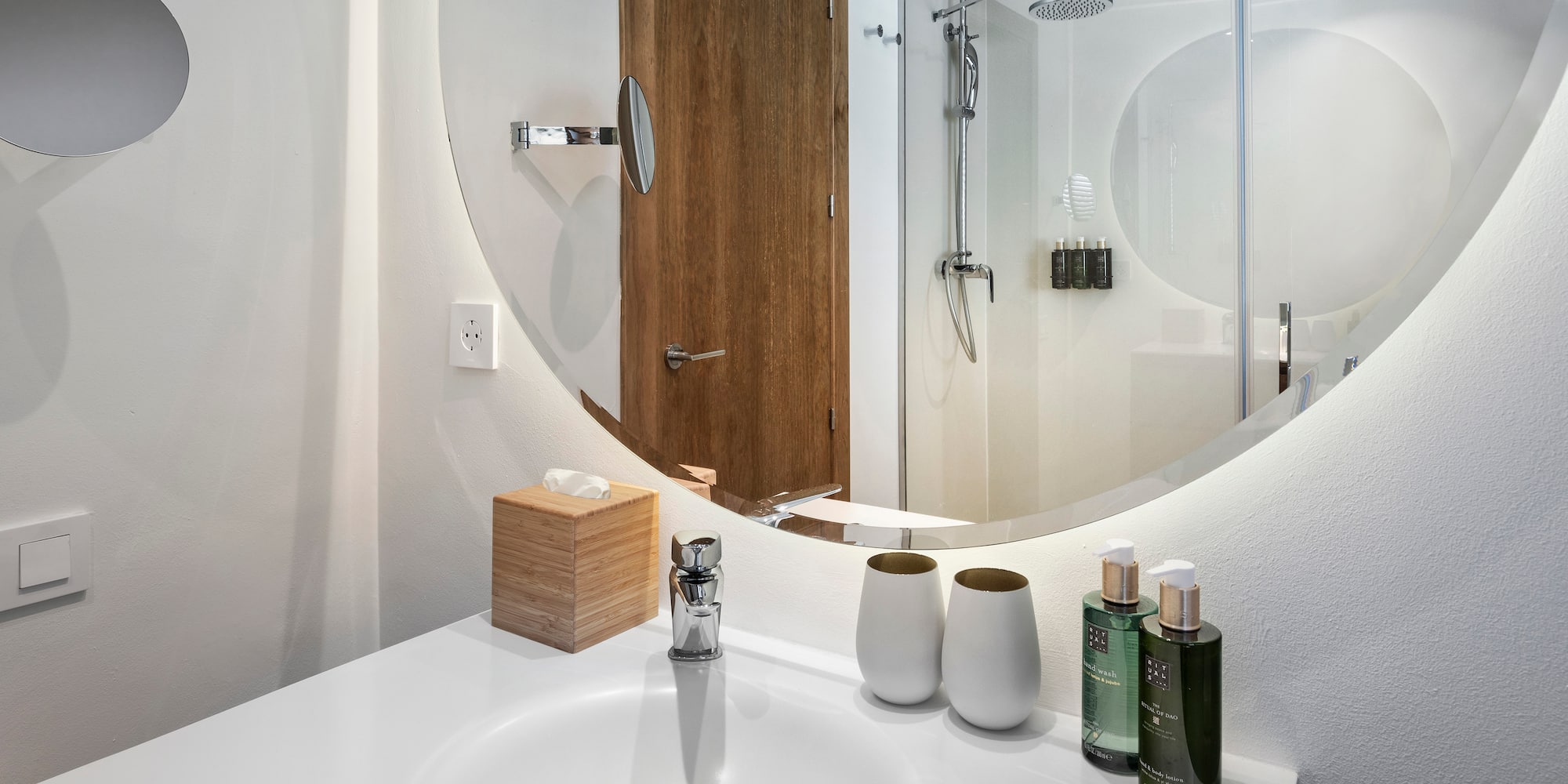 a bathroom with a round mirror