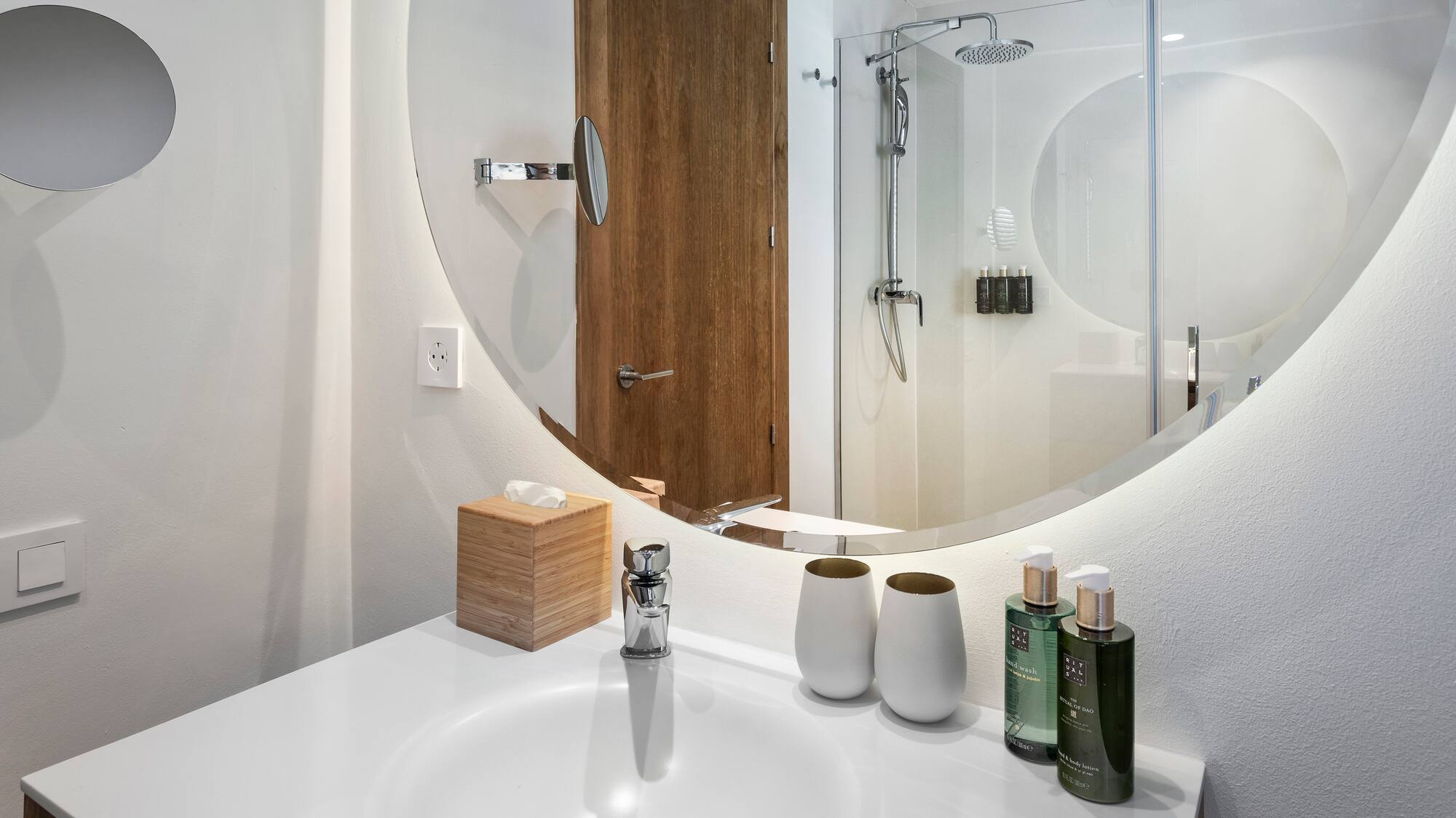 a bathroom with a round mirror