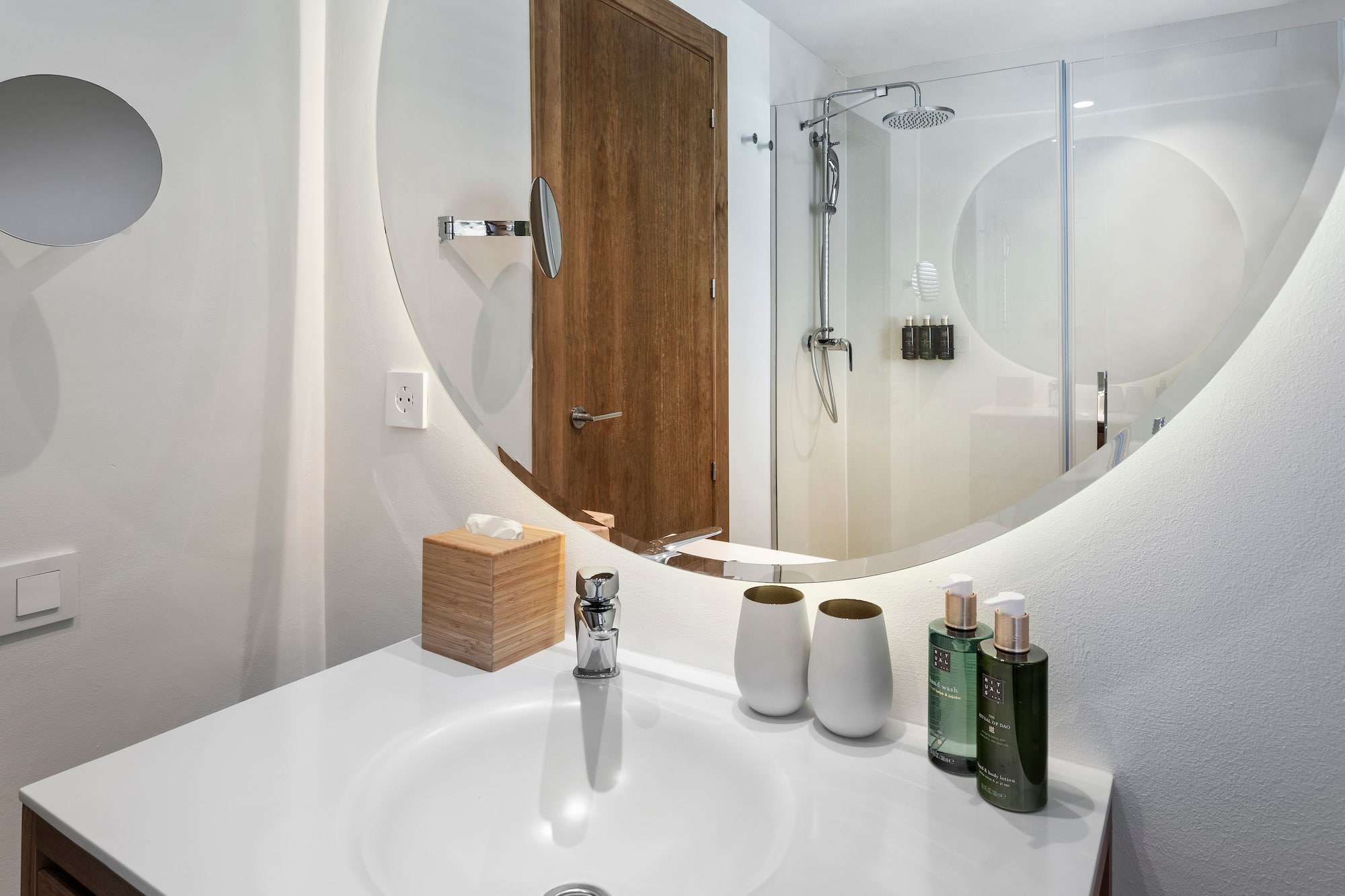 a bathroom with a round mirror