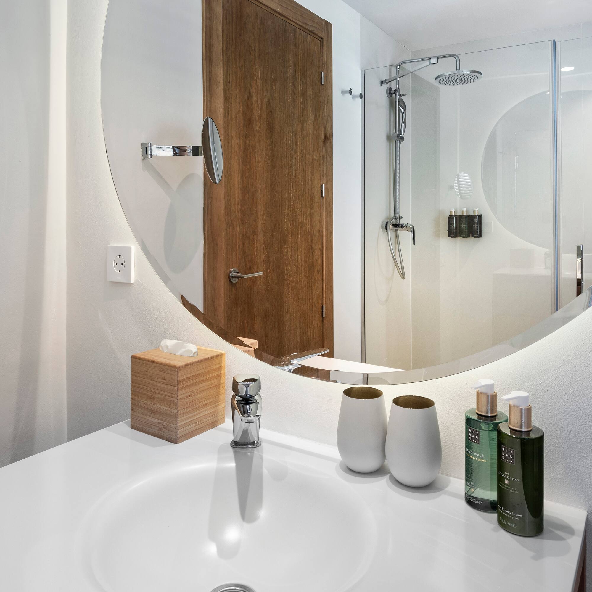 a bathroom with a round mirror
