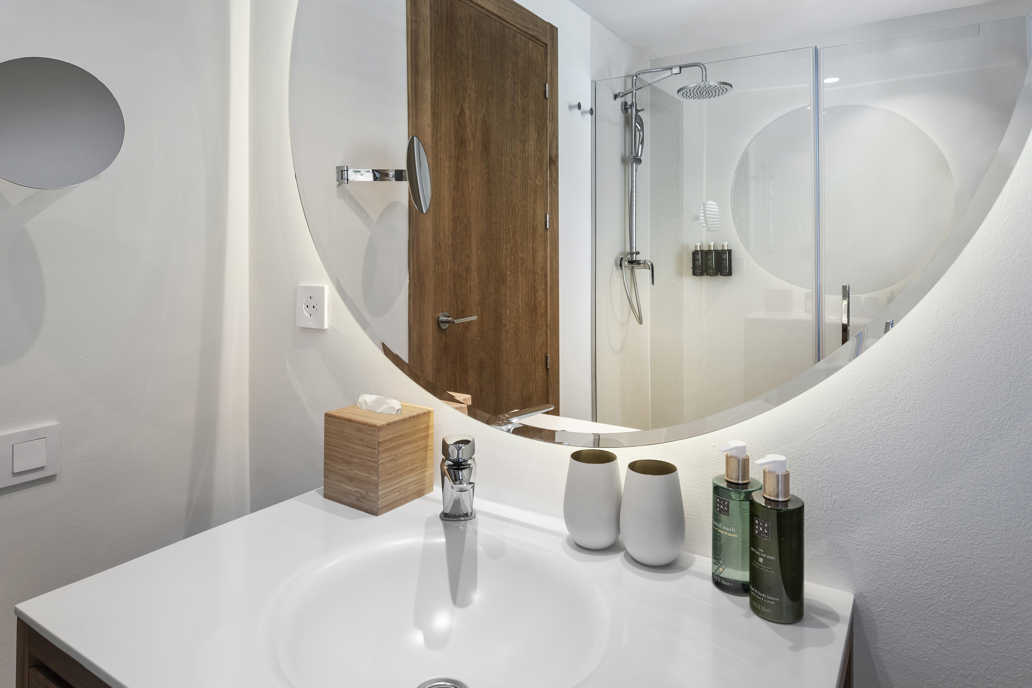 a bathroom with a round mirror