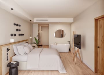 a bedroom with a bathtub and a bed