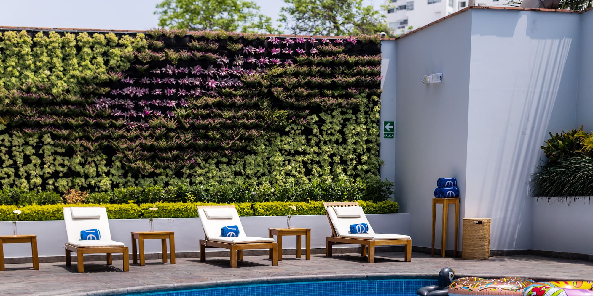 a pool with chairs and a floating object in the back