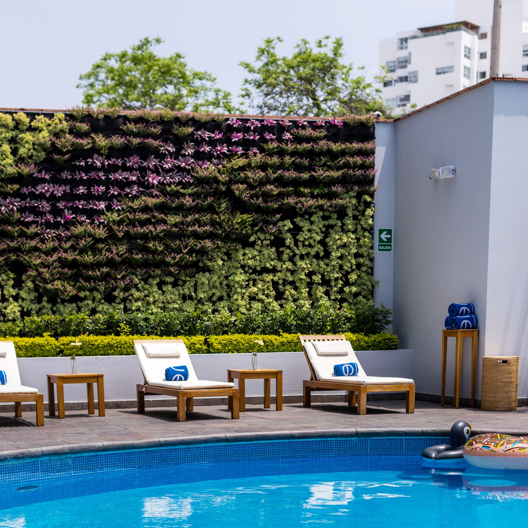 a pool with chairs and a floating object in the back
