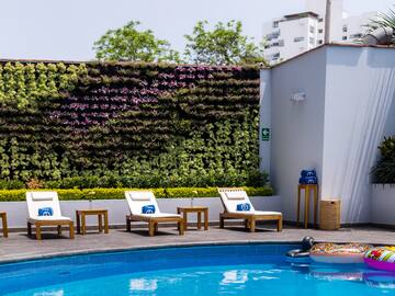a pool with chairs and a floating object in the back