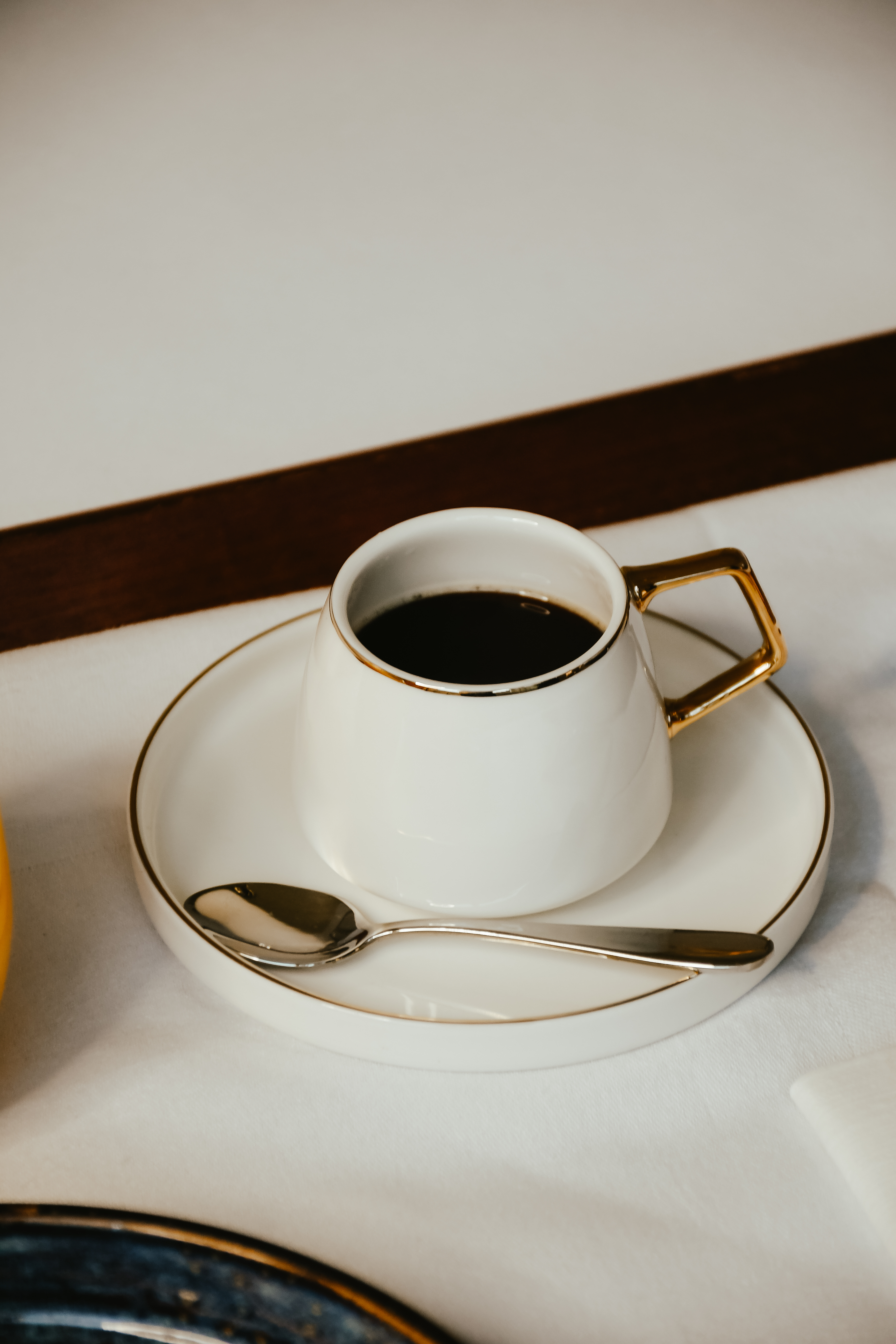 A couch sits with a coffee table in front of it, and a bag rests on the couch.