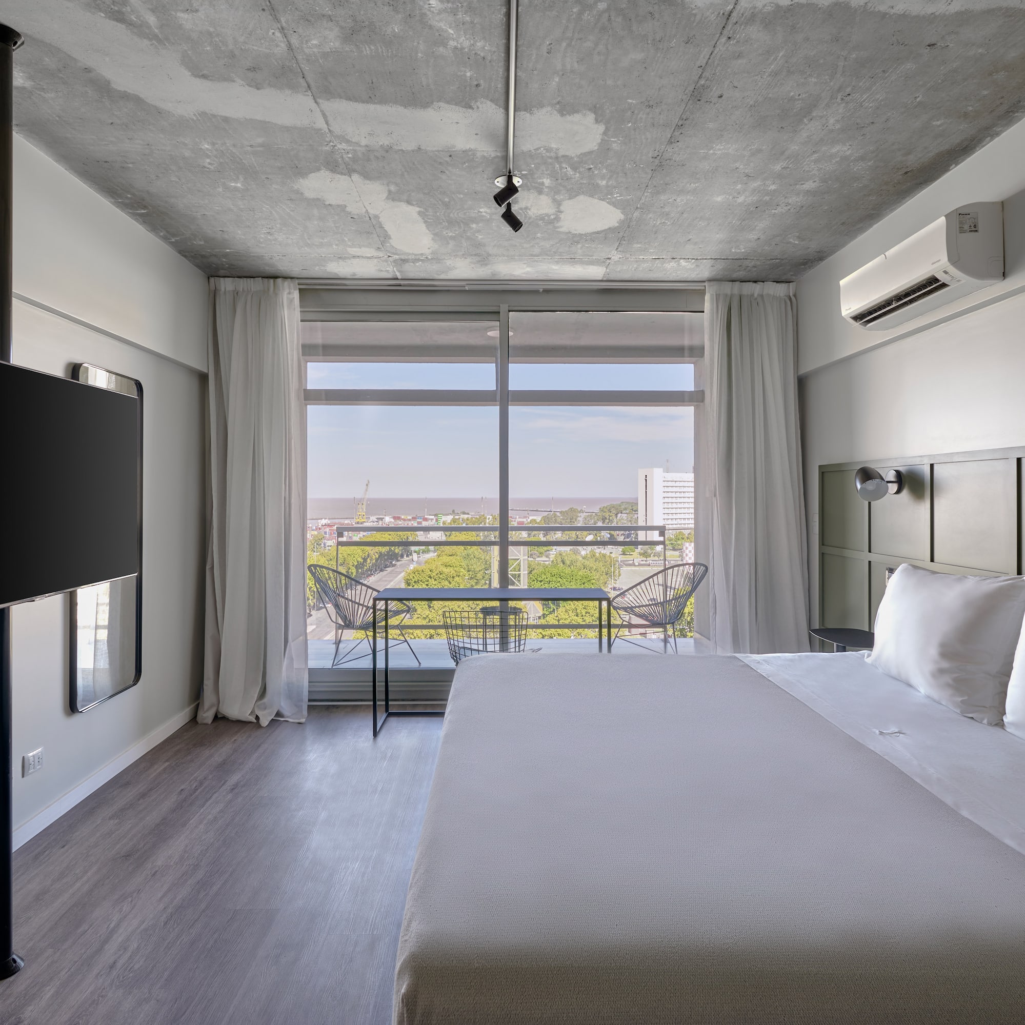 a room with a large bed and a television