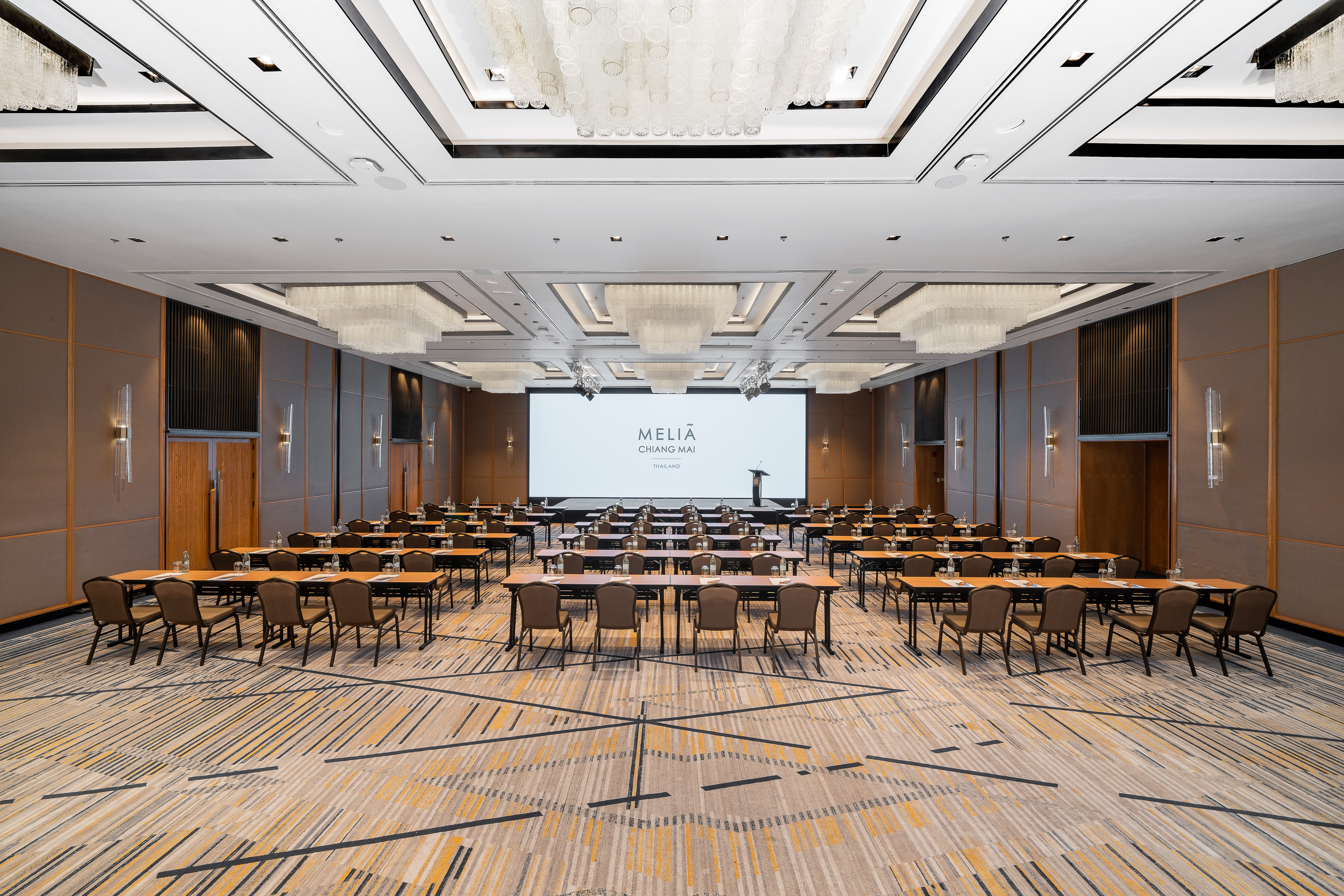 Meliá Chiang Mai hotel conference ballroom with screen and event setup.