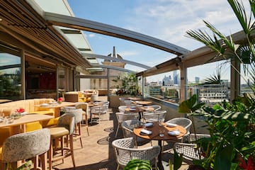 a patio with tables and chairs