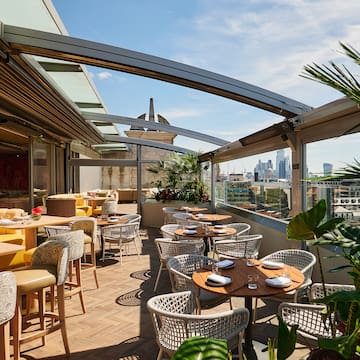 a patio with tables and chairs