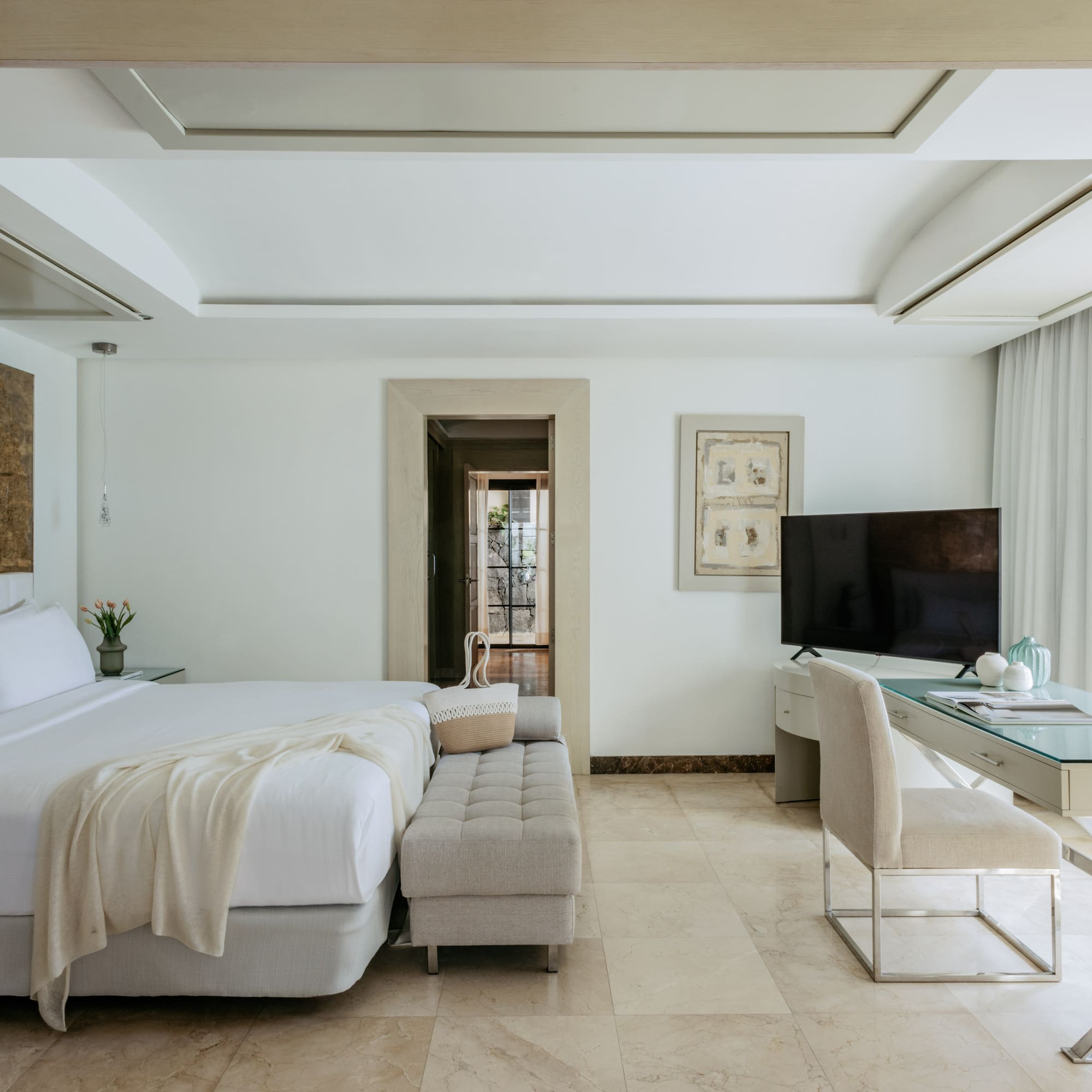 a bedroom with a large bed and a desk