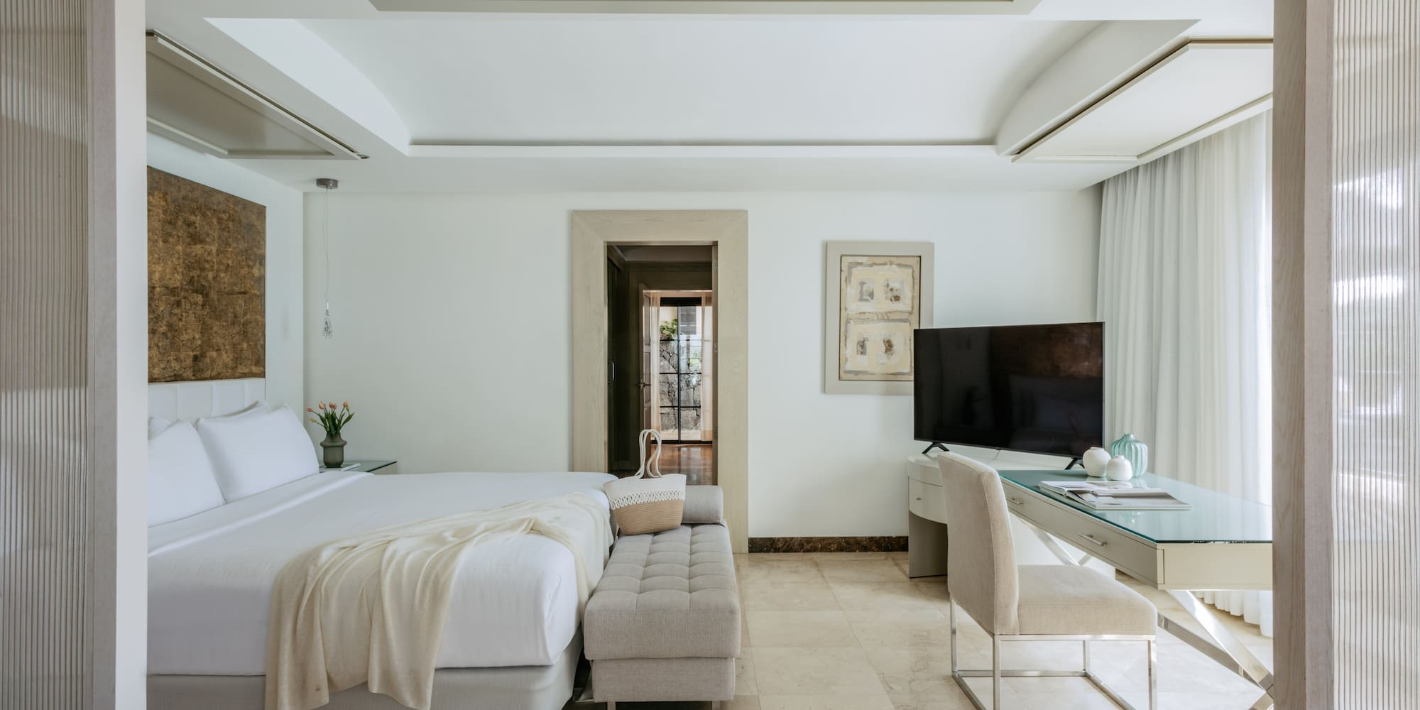 a bedroom with a large bed and a desk