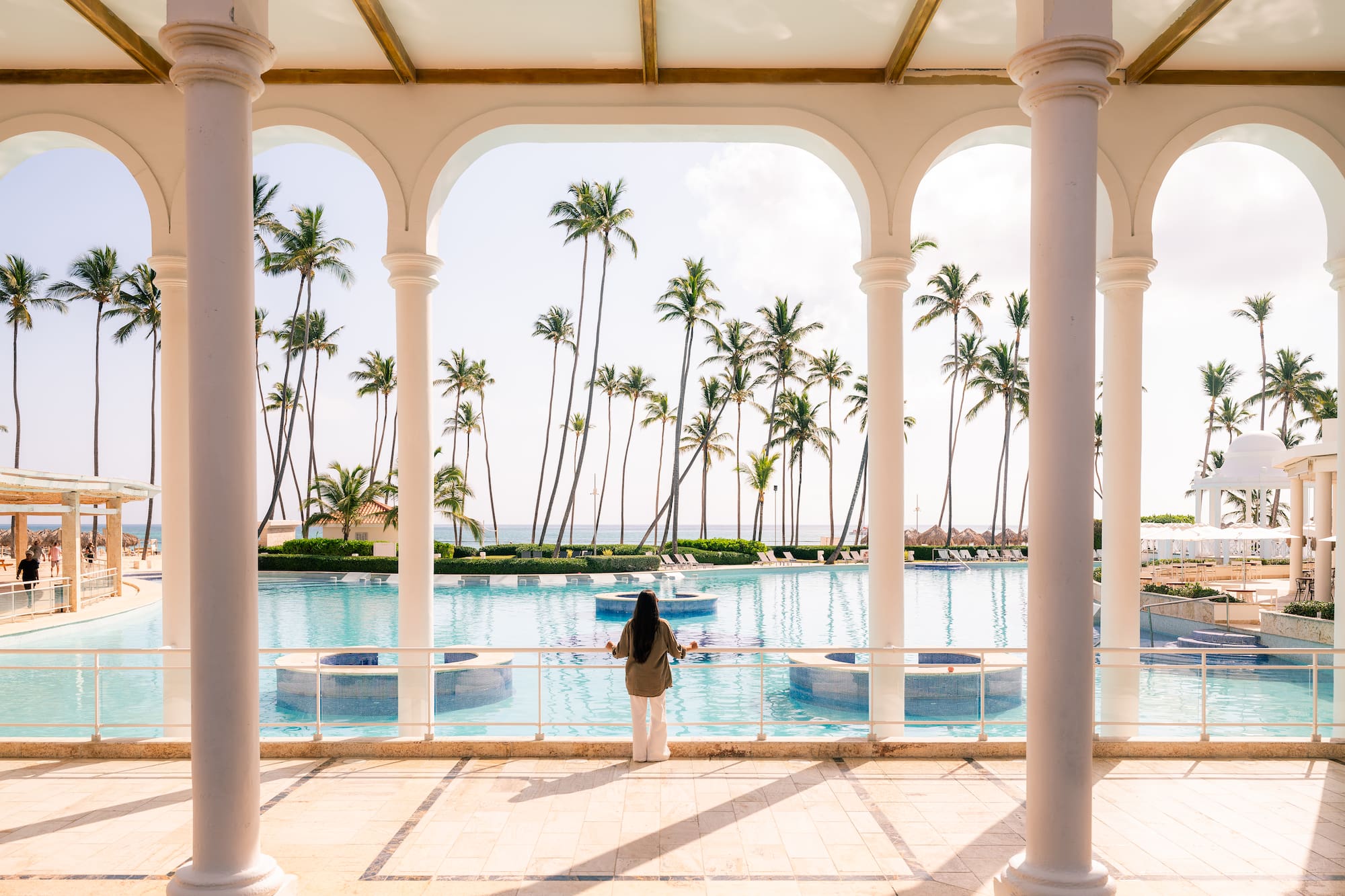a woman standing in front of a pool