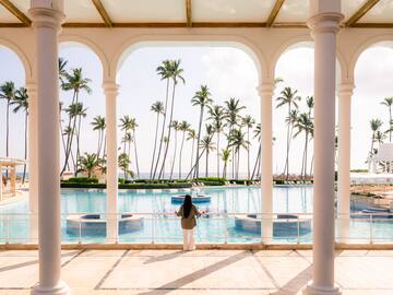 a woman standing in front of a pool