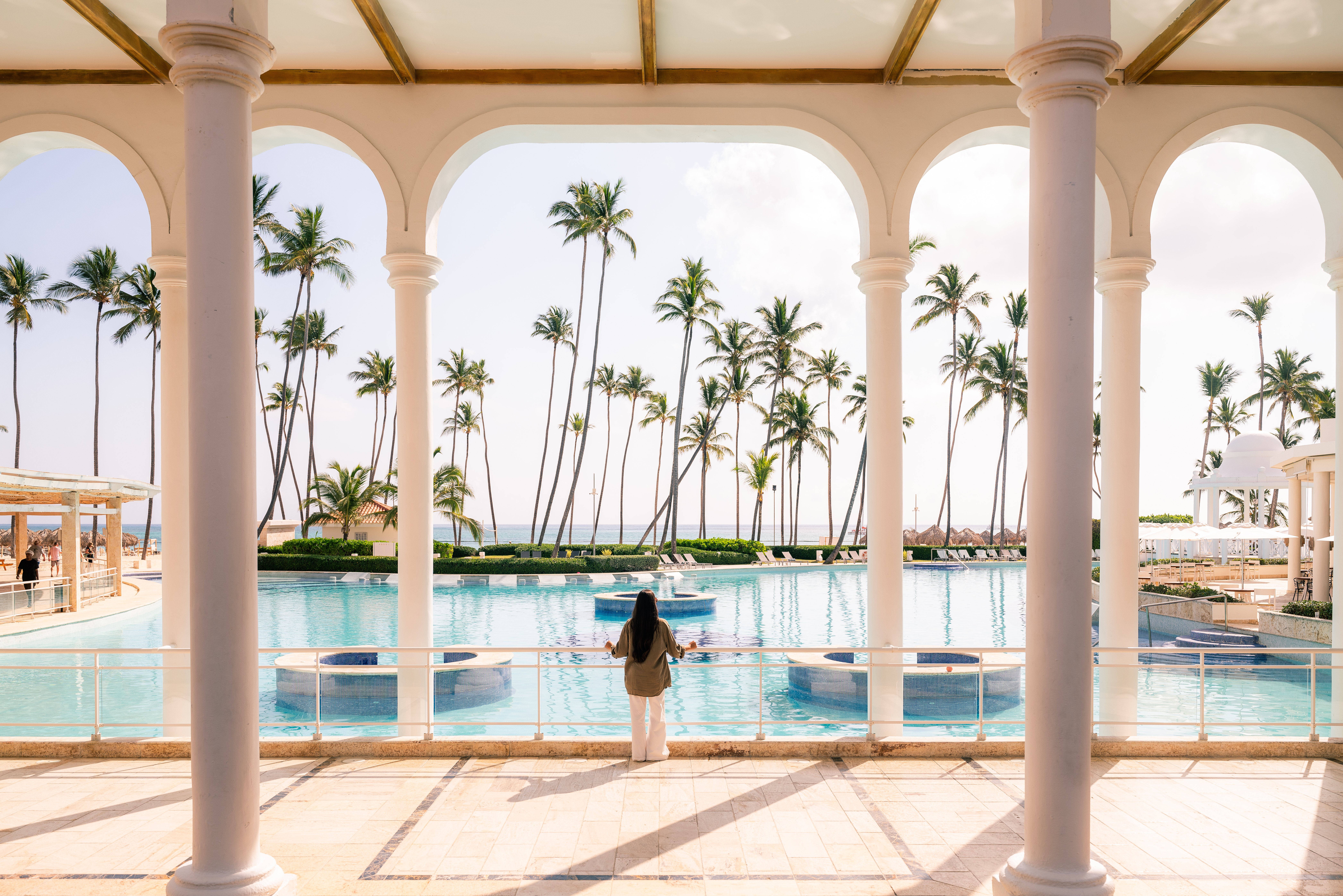 a woman standing in front of a pool