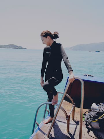 a woman in a wet suit on a boat