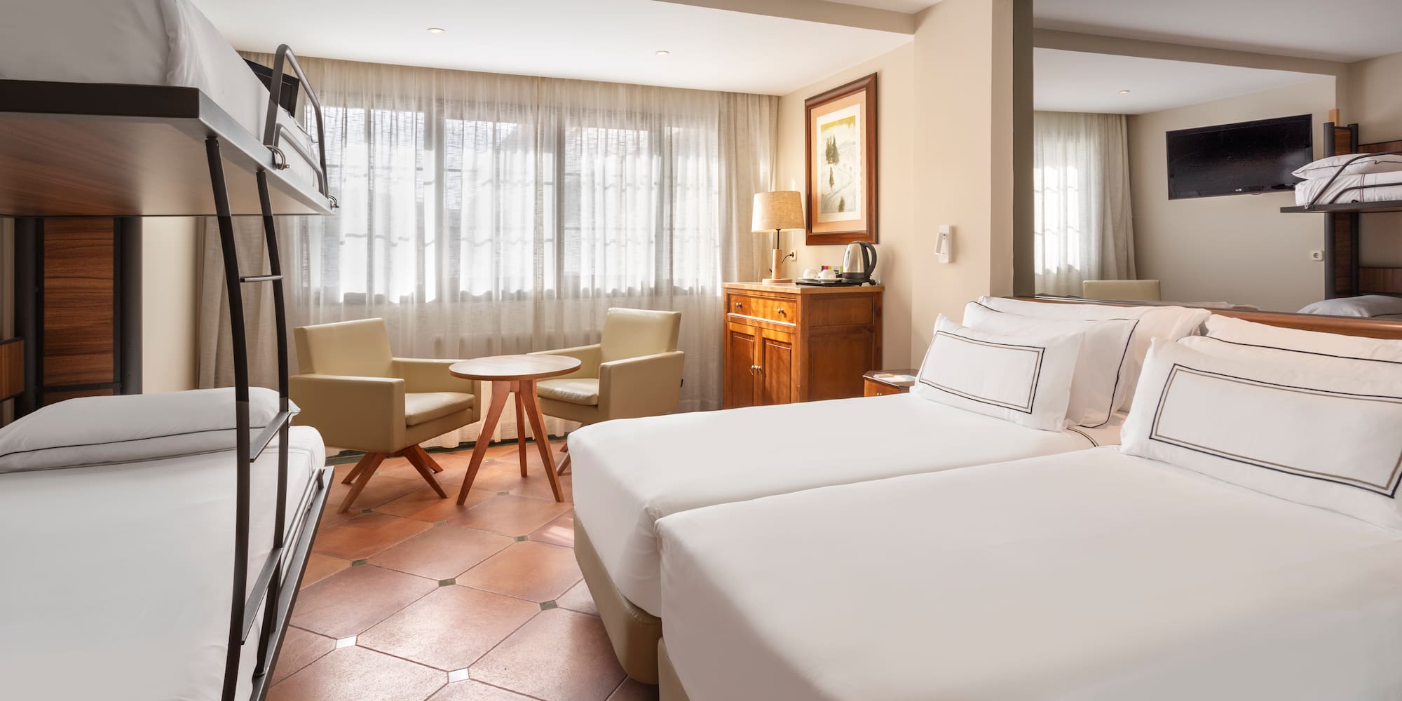 a room with a bed and a television