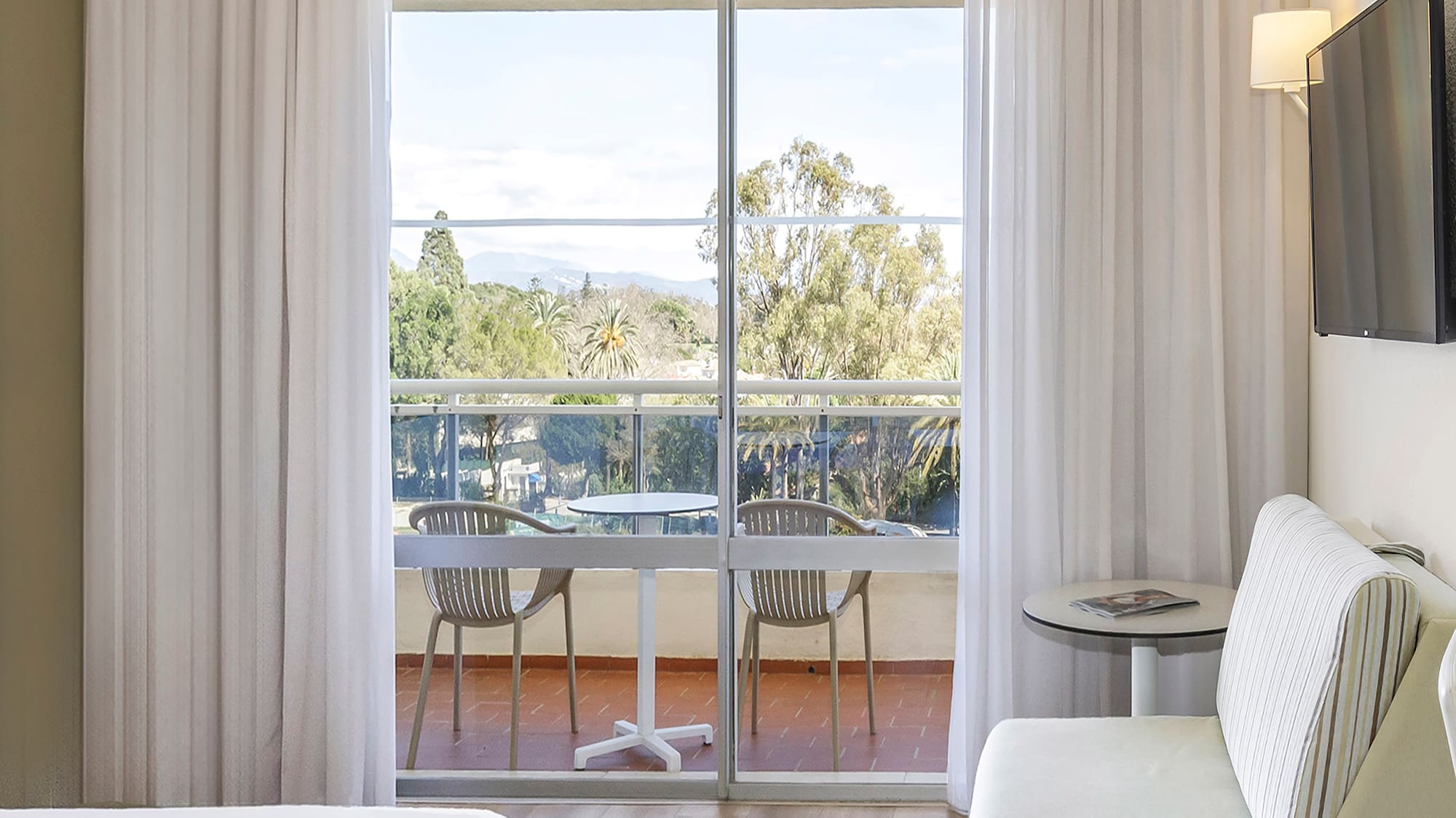 a room with a bed and a television on the wall