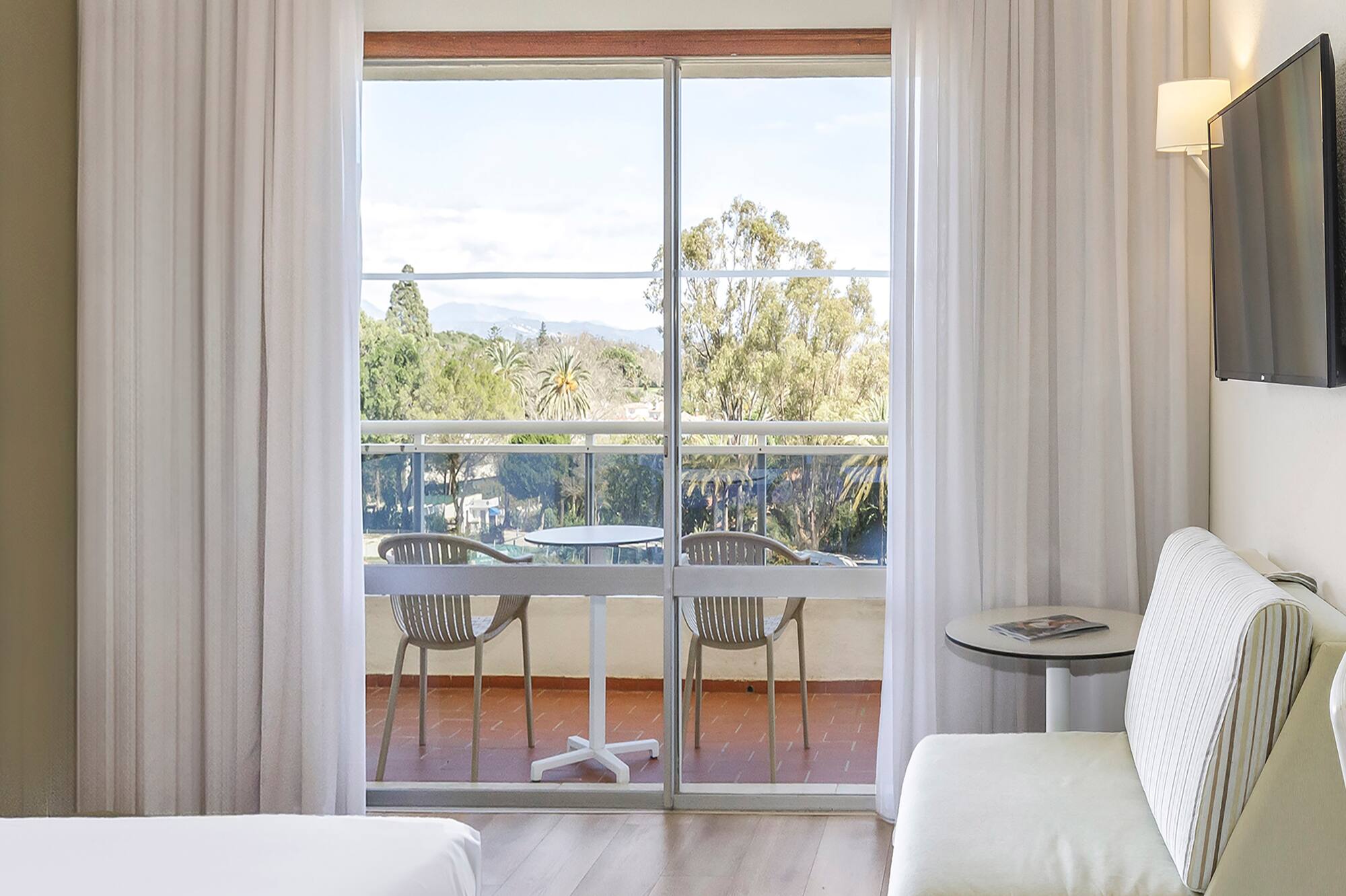 a room with a bed and a television on the wall