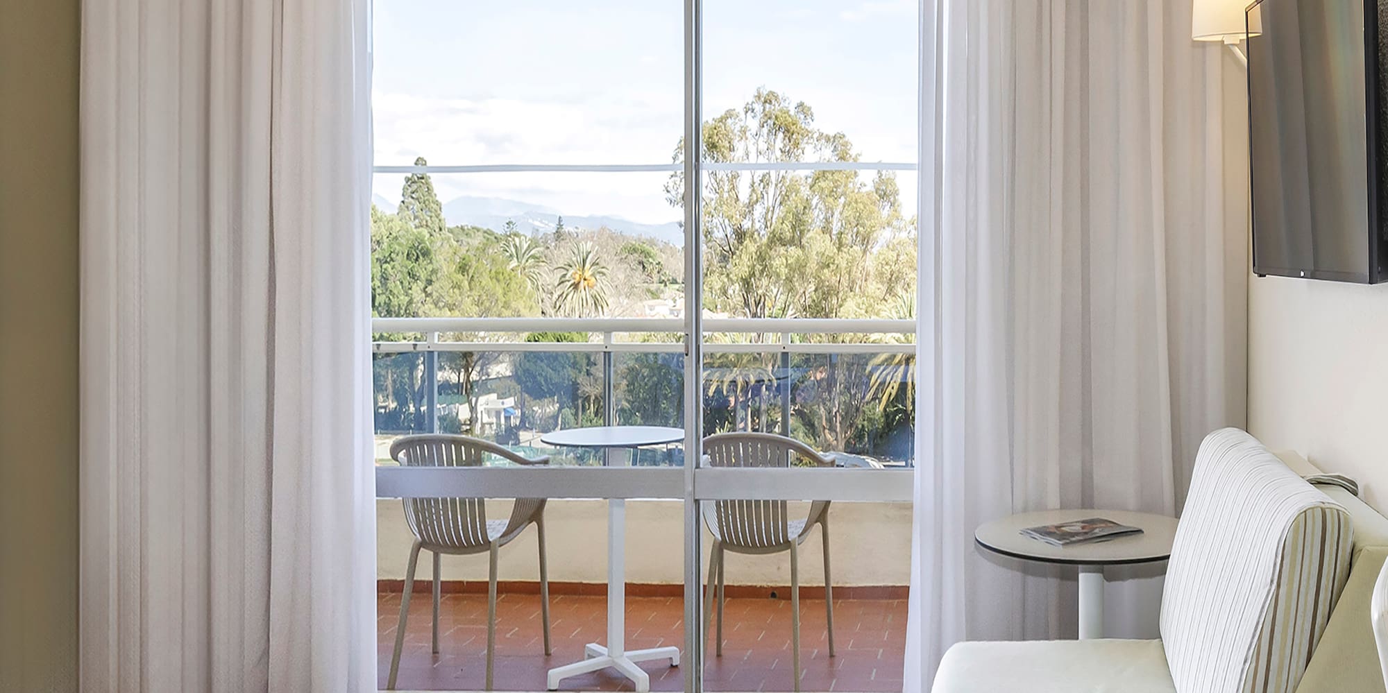 a room with a bed and a television on the wall