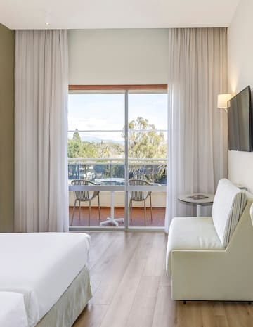 a room with a bed and a television on the wall