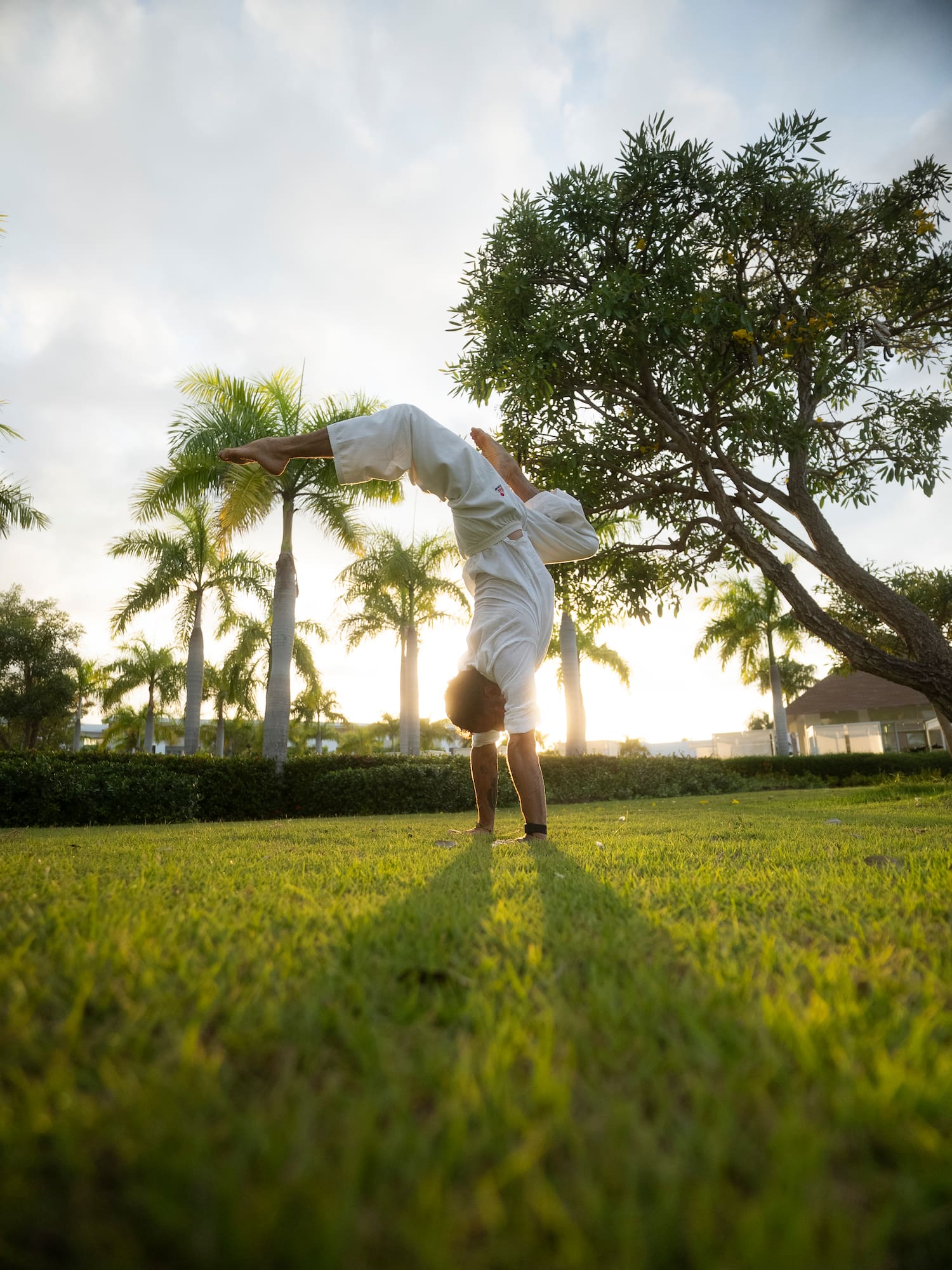 a man doing a hand stand on grass