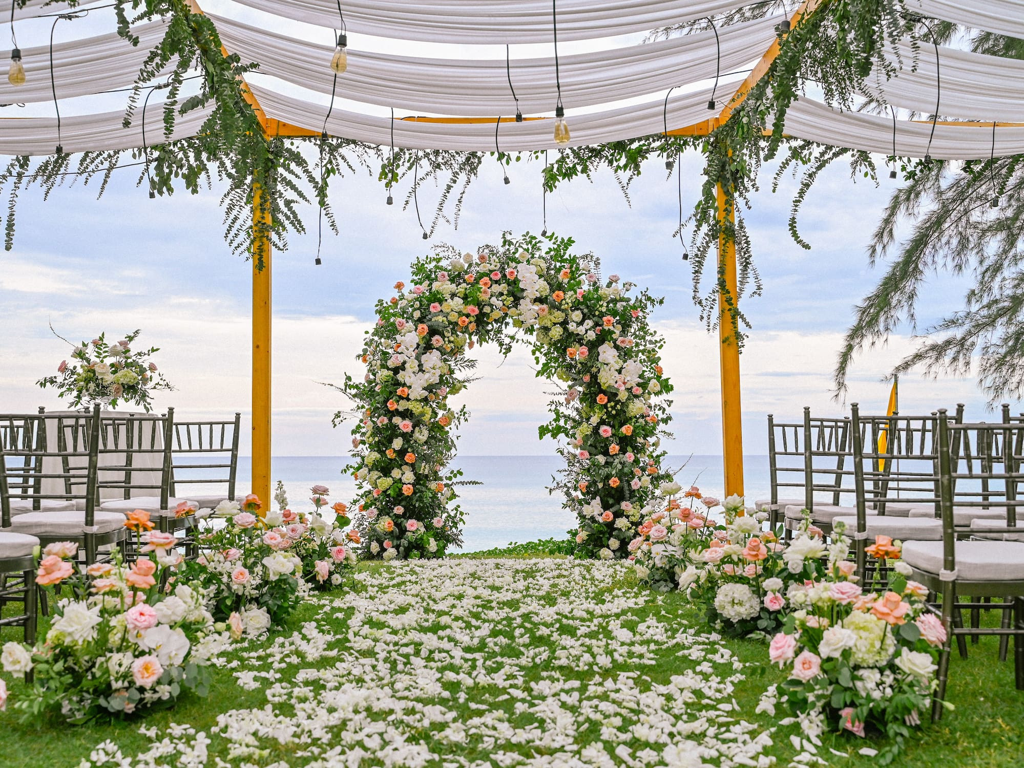 a wedding ceremony with flowers and chairs