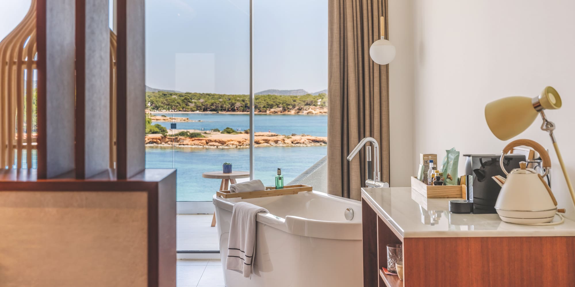Modern bathroom with freestanding tub and stunning ocean view.
