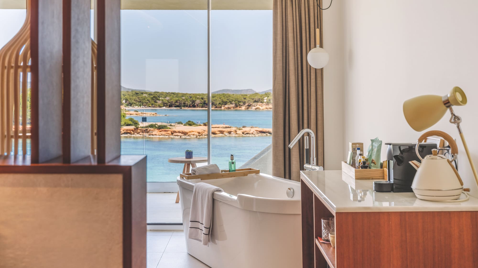 Modern bathroom with freestanding tub and stunning ocean view.