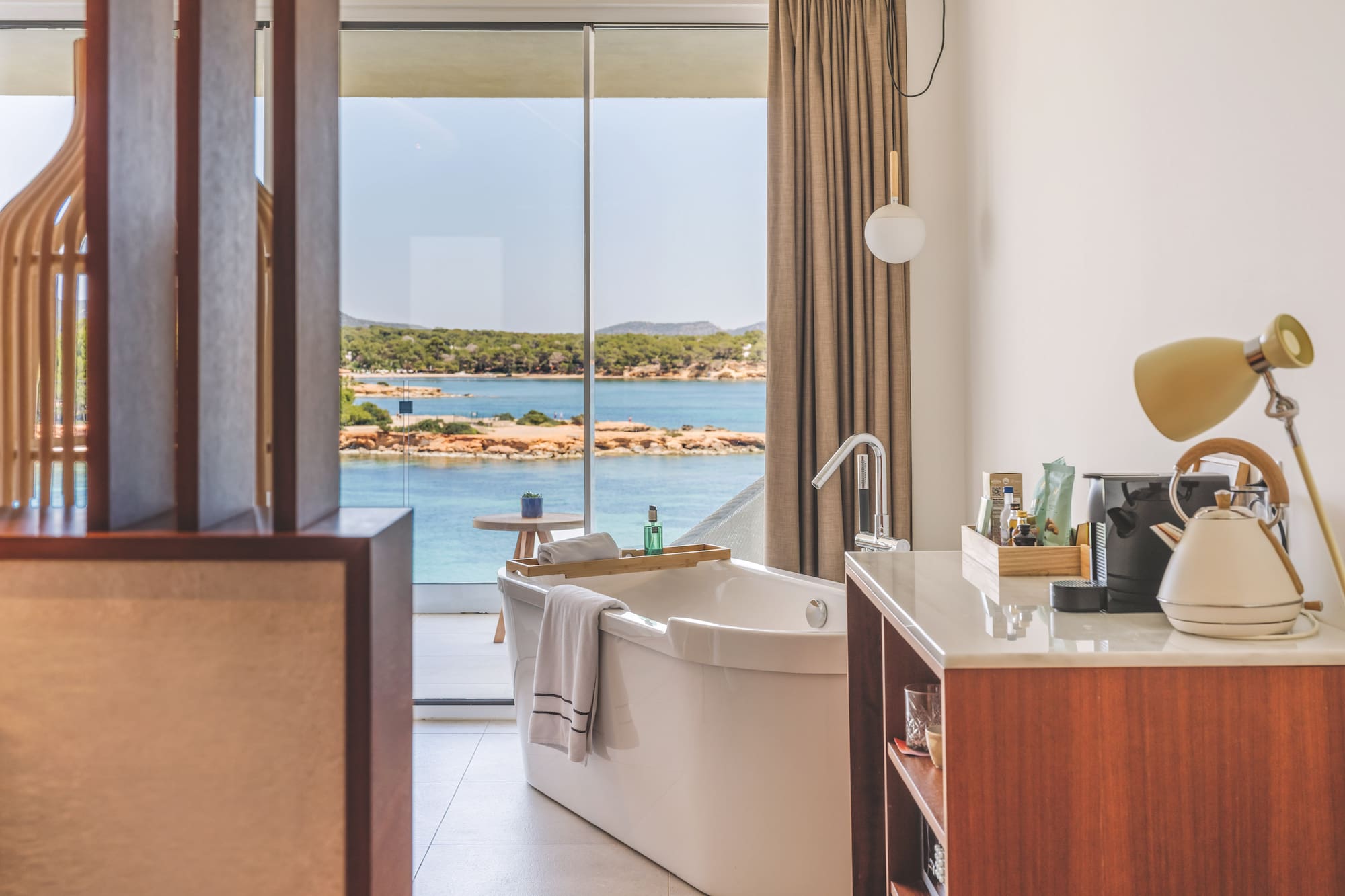 Modern bathroom with freestanding tub and stunning ocean view.