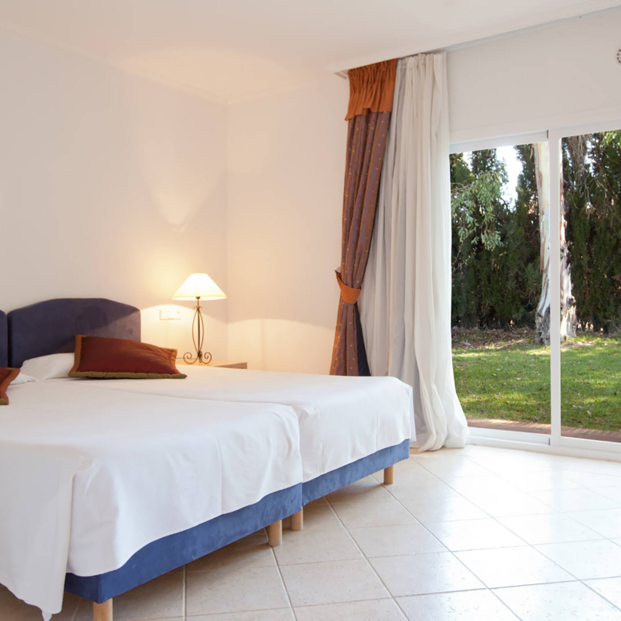 a bedroom with a bed and a glass door