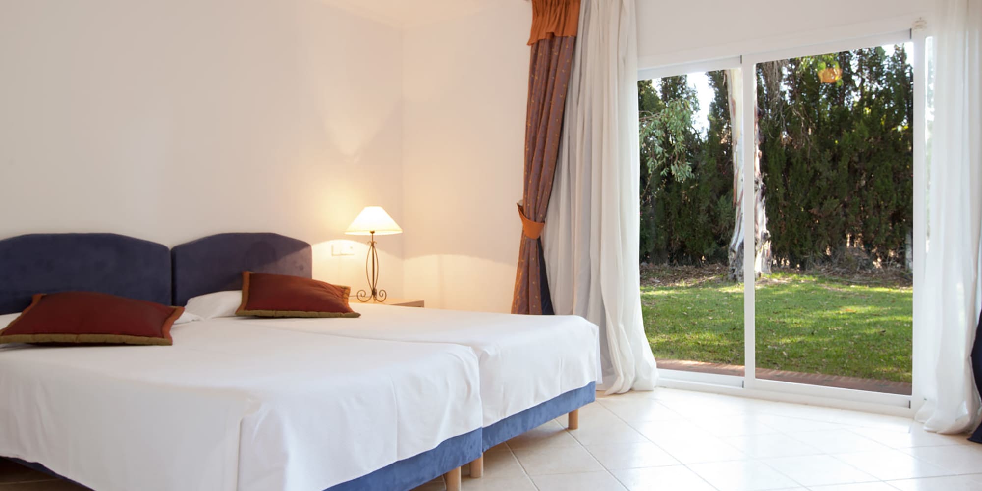 a bedroom with a bed and a glass door