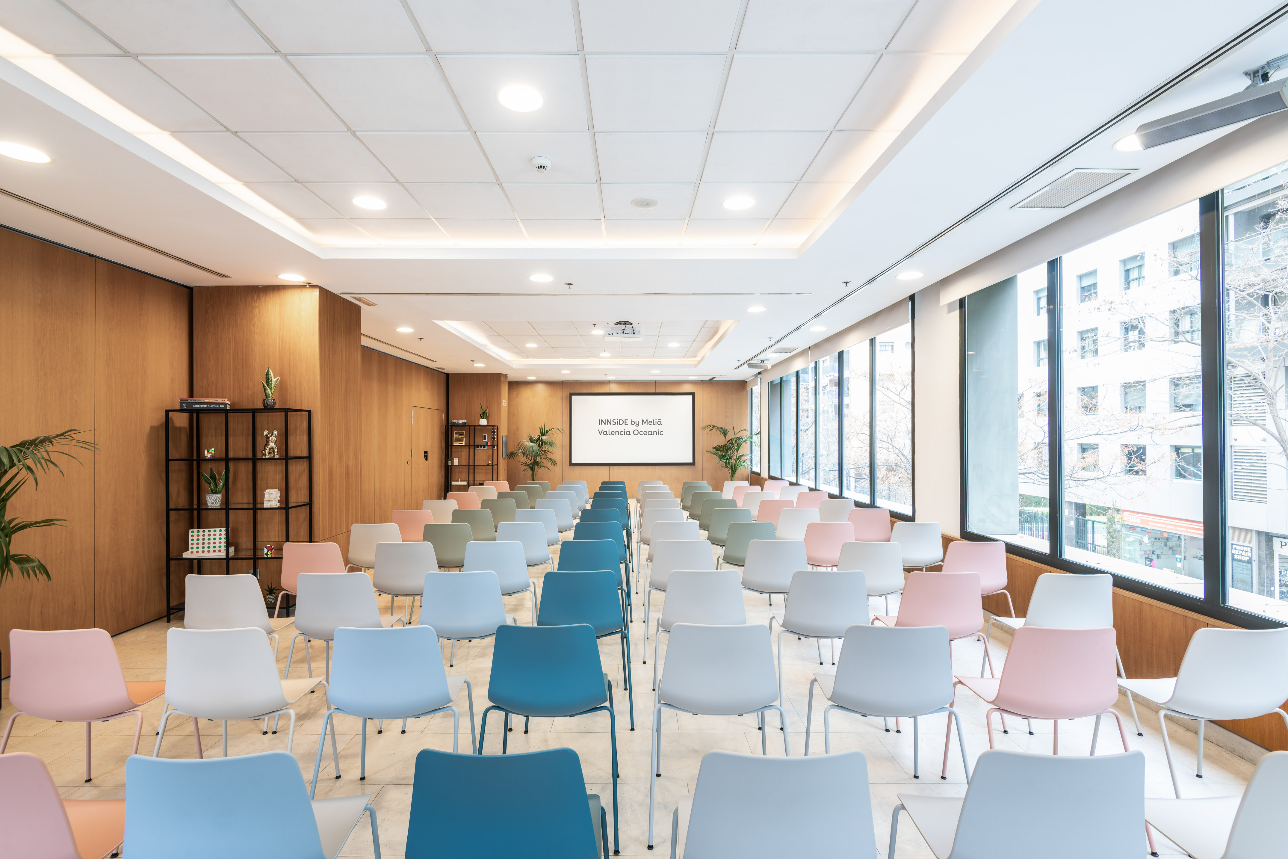 INNSIDE by Meliá Valencia Oceanic conference room with colorful chairs.
