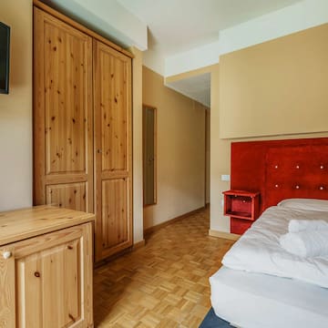 a bedroom with a bed and a tv