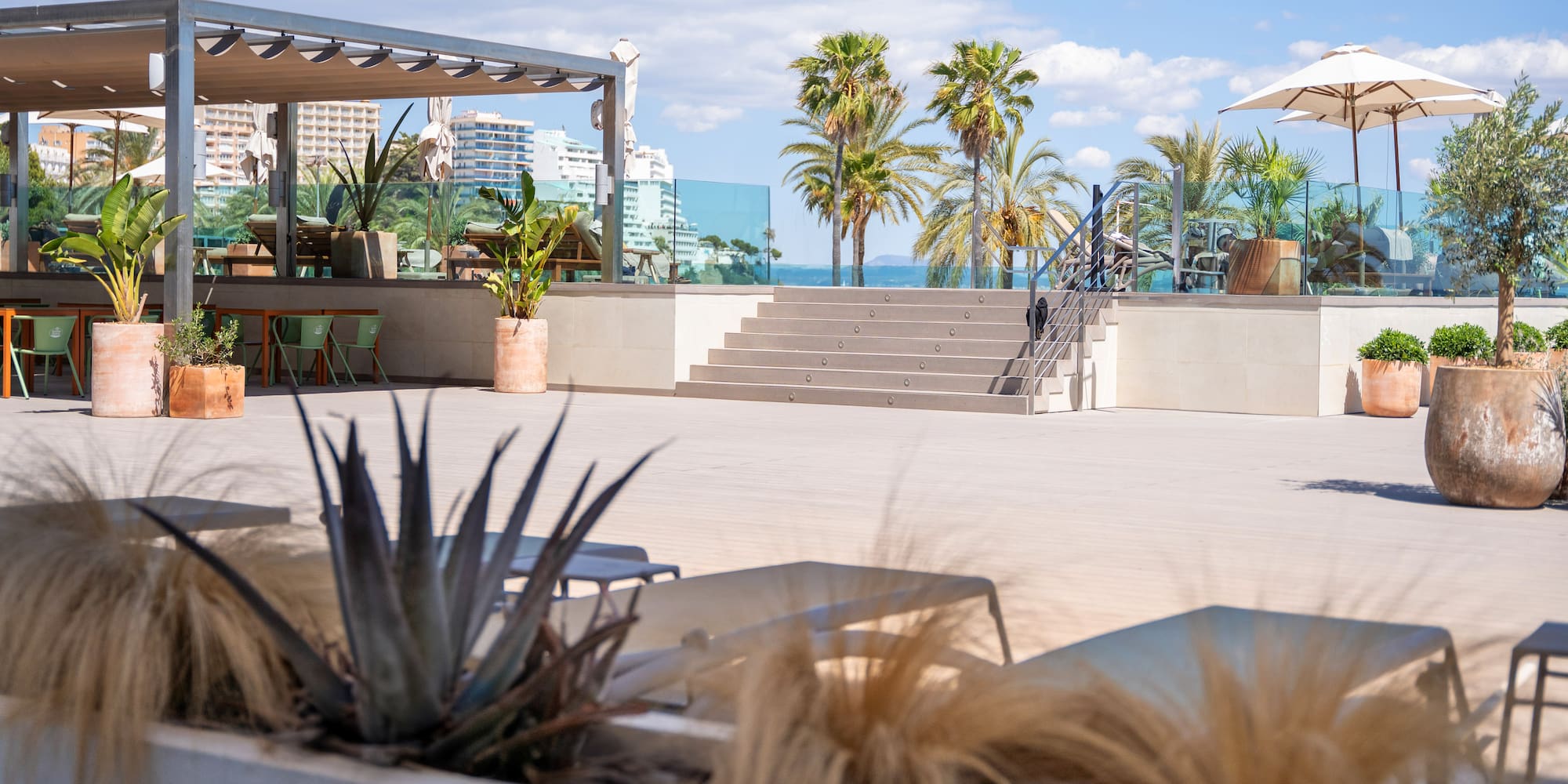 a patio with chairs and palm trees
