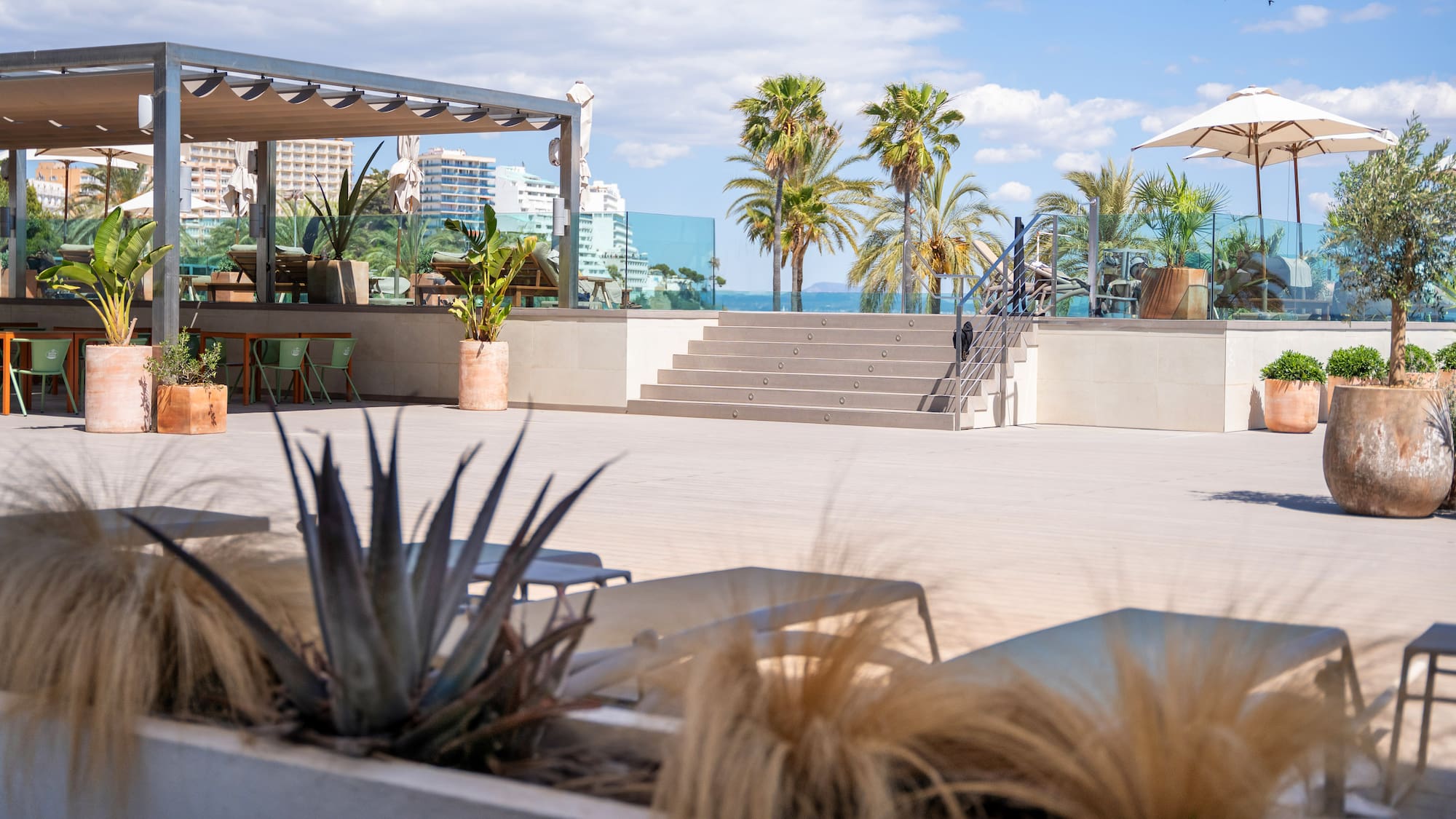 a patio with chairs and palm trees