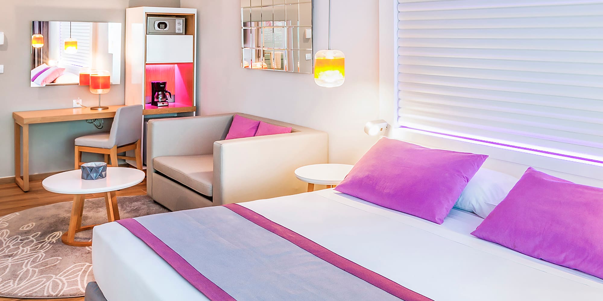 a room with a bed and a table and chairs