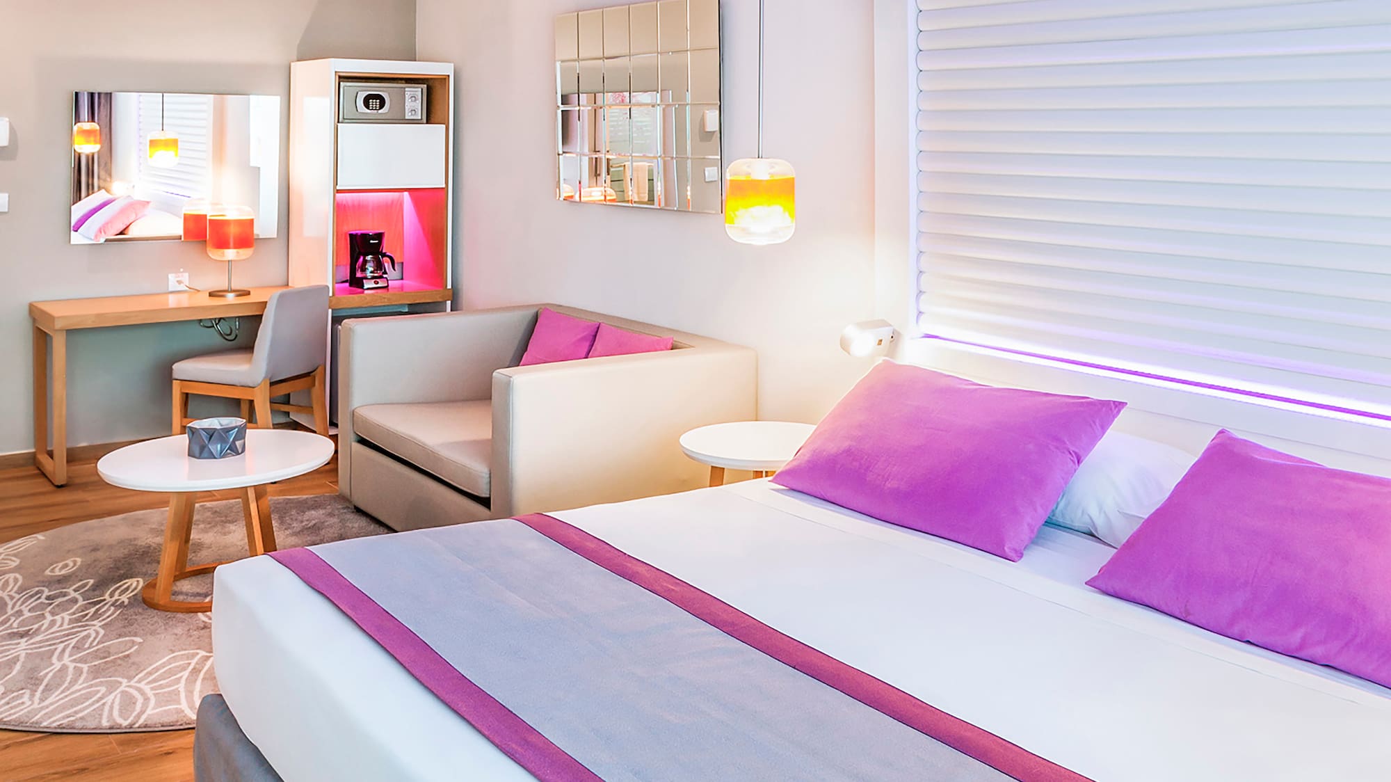 a room with a bed and a table and chairs