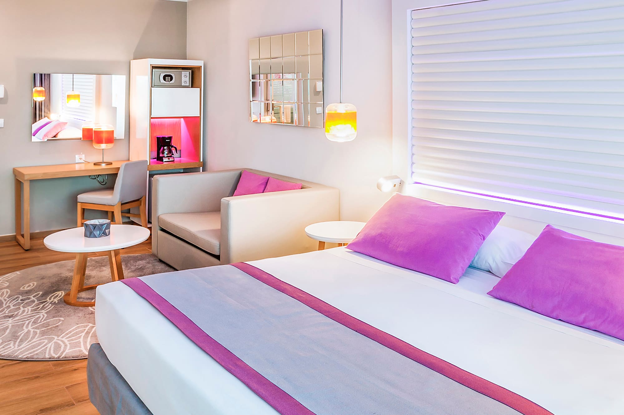 a room with a bed and a table and chairs