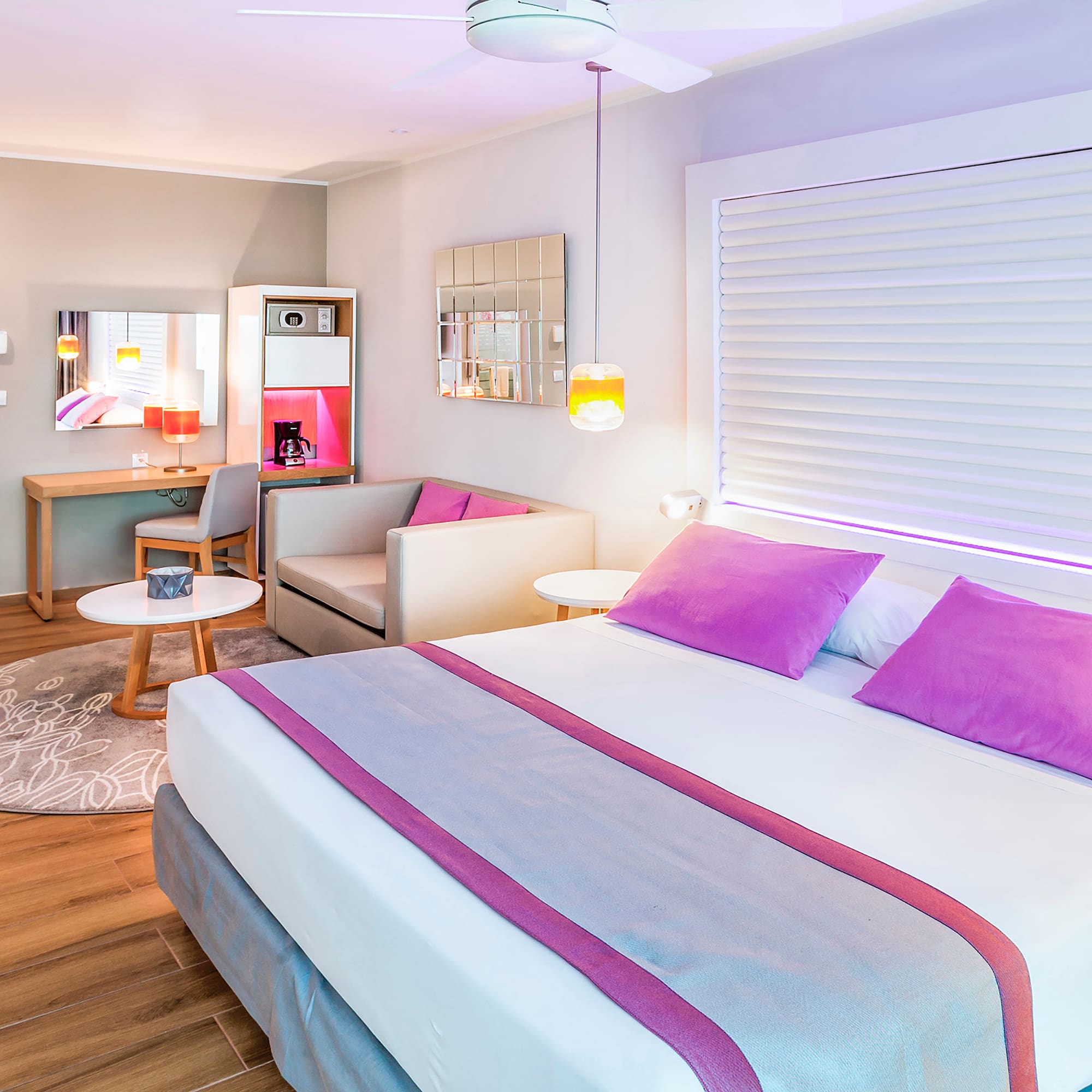 a room with a bed and a table and chairs