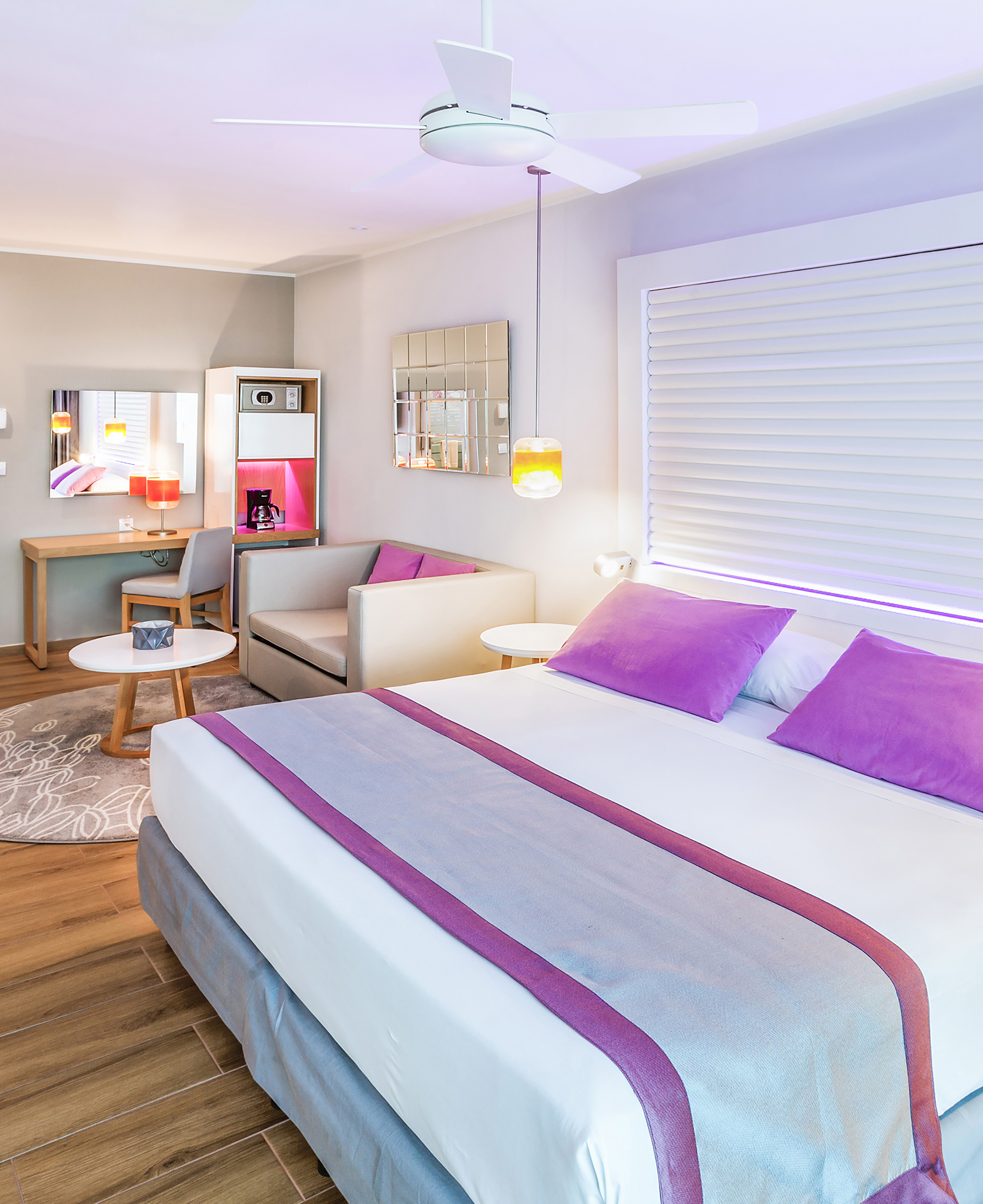 a room with a bed and a table and chairs