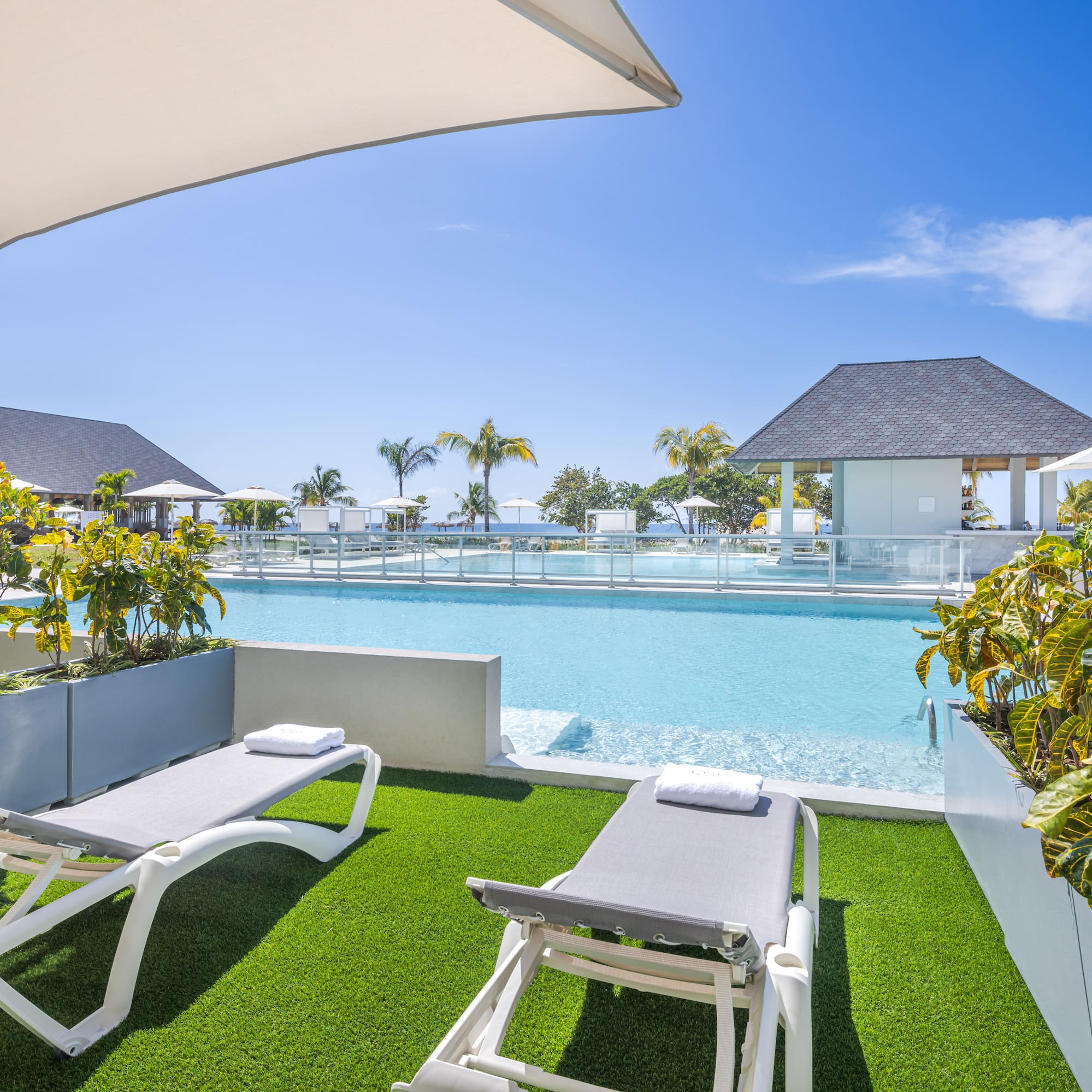 a pool with lounge chairs and a gazebo