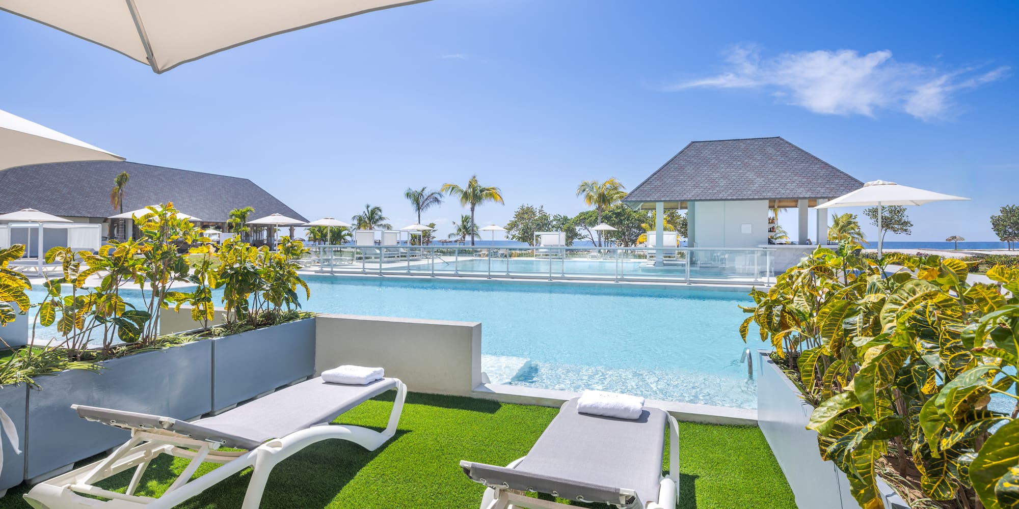 a pool with lounge chairs and a gazebo