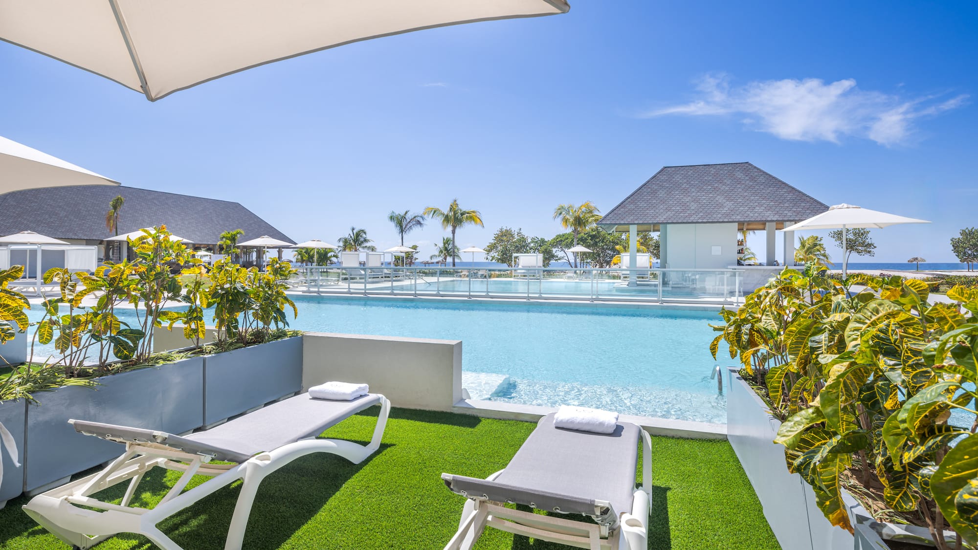 a pool with lounge chairs and a gazebo