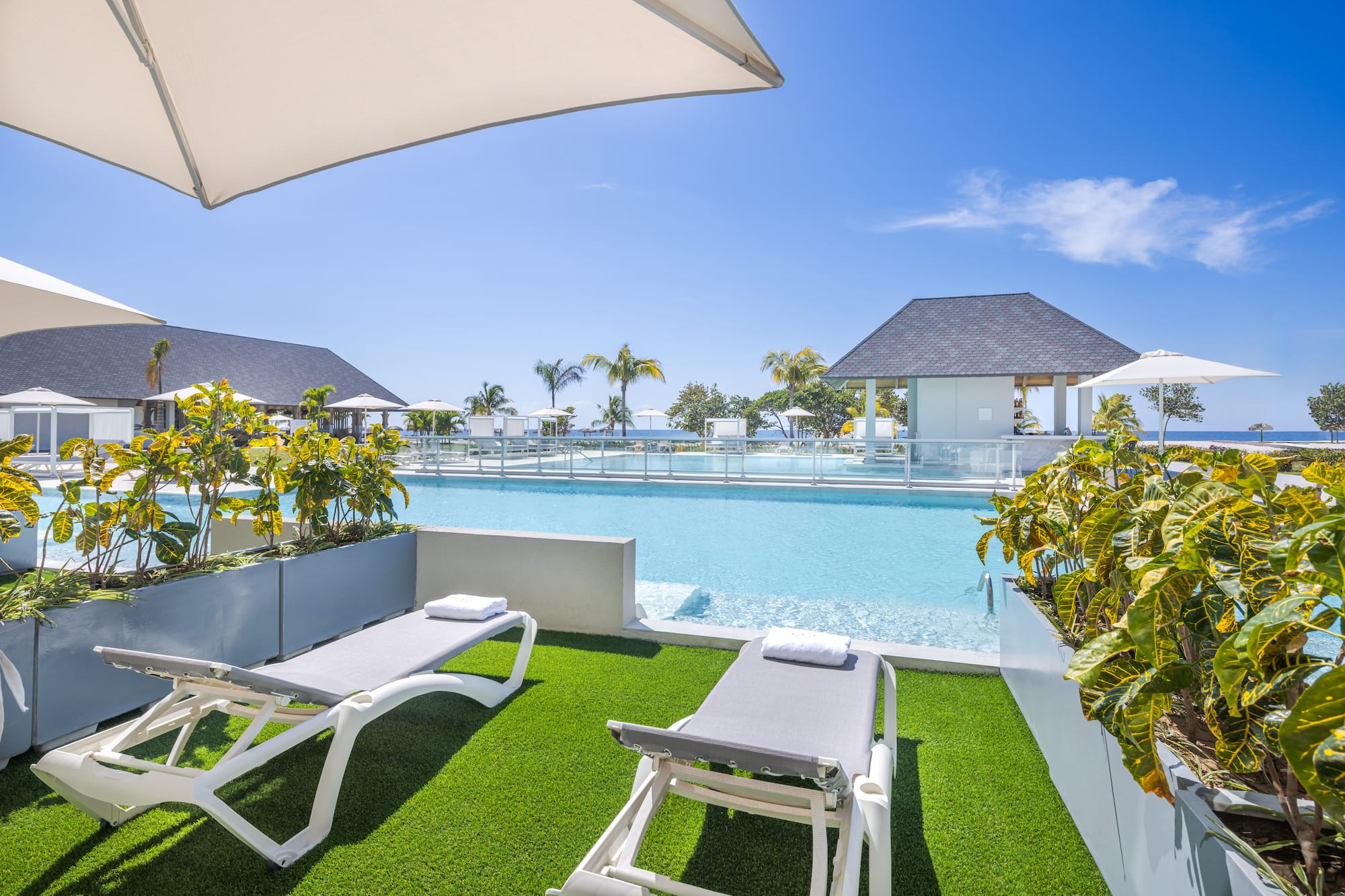 a pool with lounge chairs and a gazebo