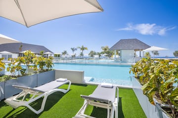 a pool with lounge chairs and a gazebo