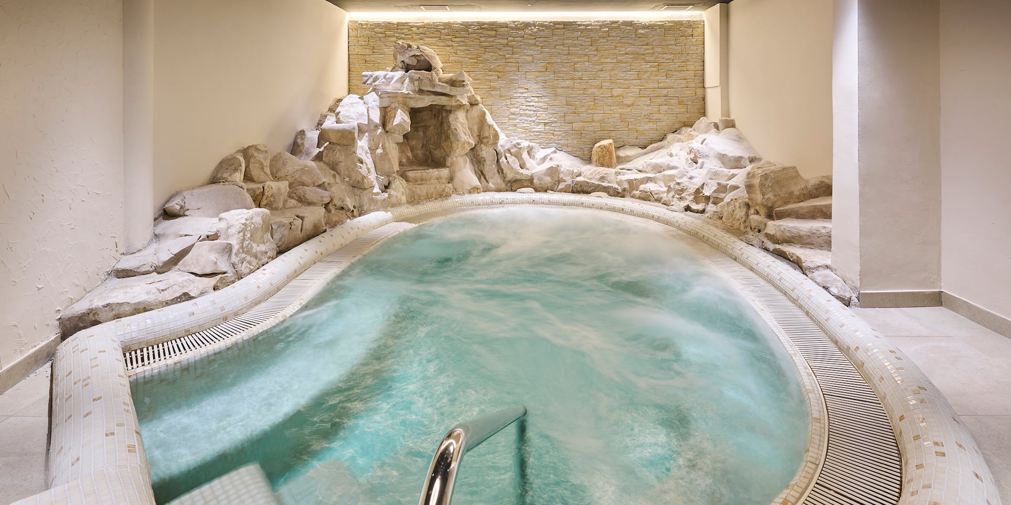 a indoor hot tub with rocks around it