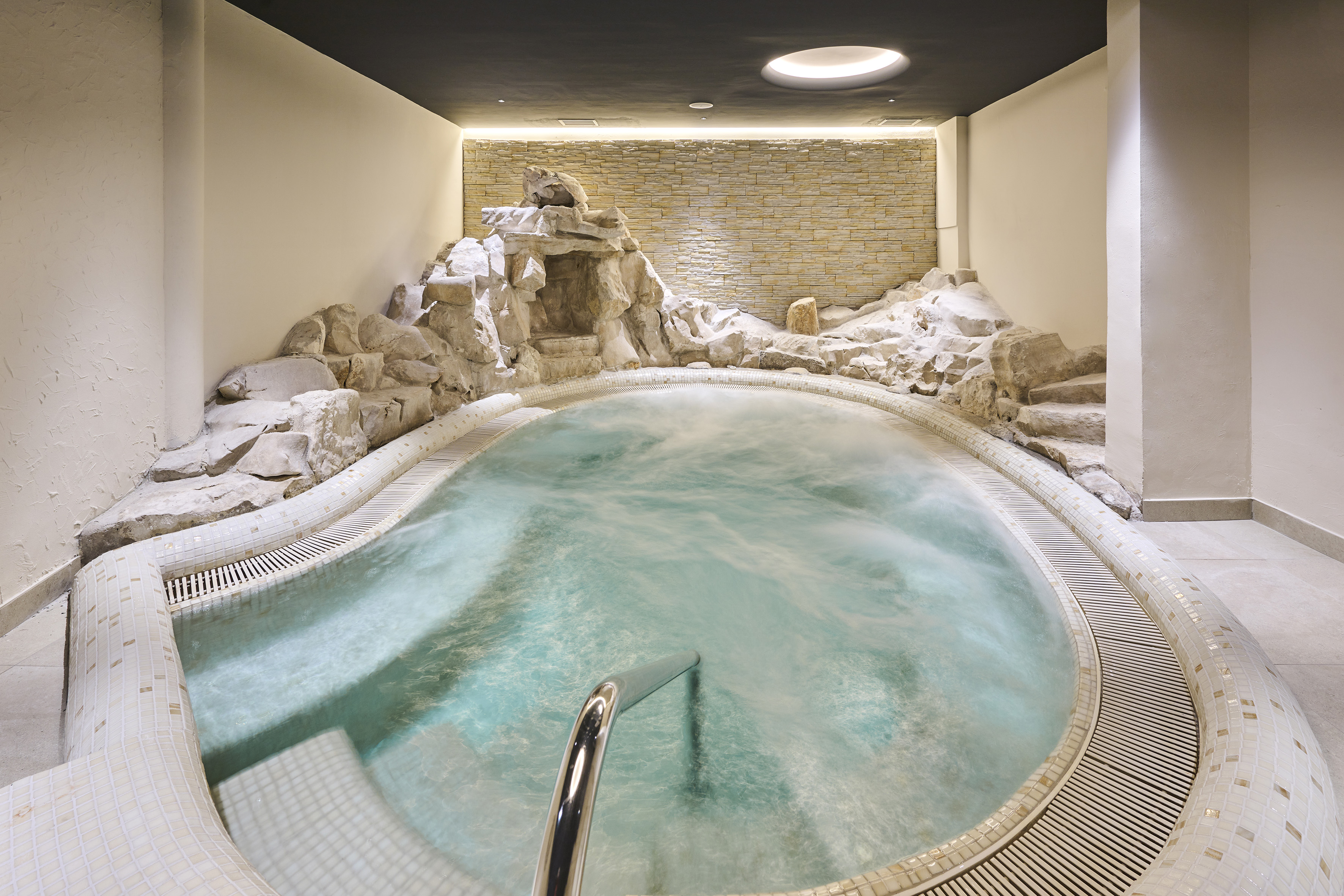a indoor hot tub with rocks around it