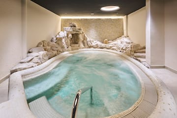 a indoor hot tub with rocks around it