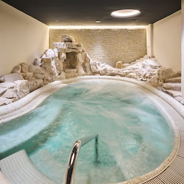 a indoor hot tub with rocks around it